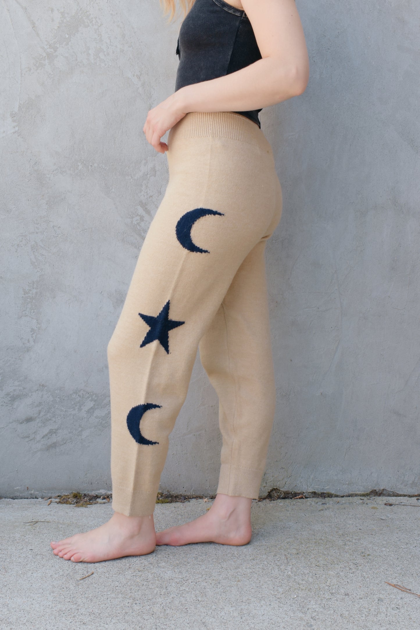 cream knit joggers with slightly elastic wide waistband, high waisted, moon and star design on sides of leg, relaxed fit, no pockets