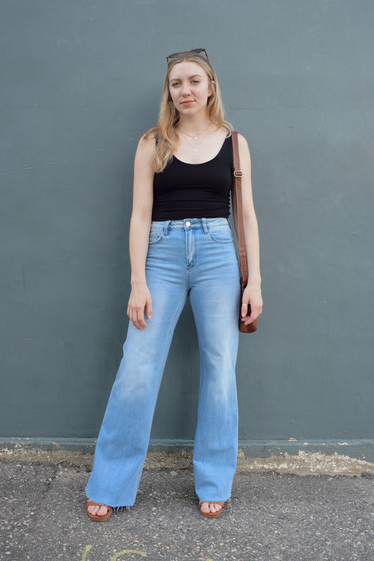 high rise full length wide leg jeans stretch denim raw hem light wash no distressing or holes, retro seam detailing above back pockets, zip and button enclosure