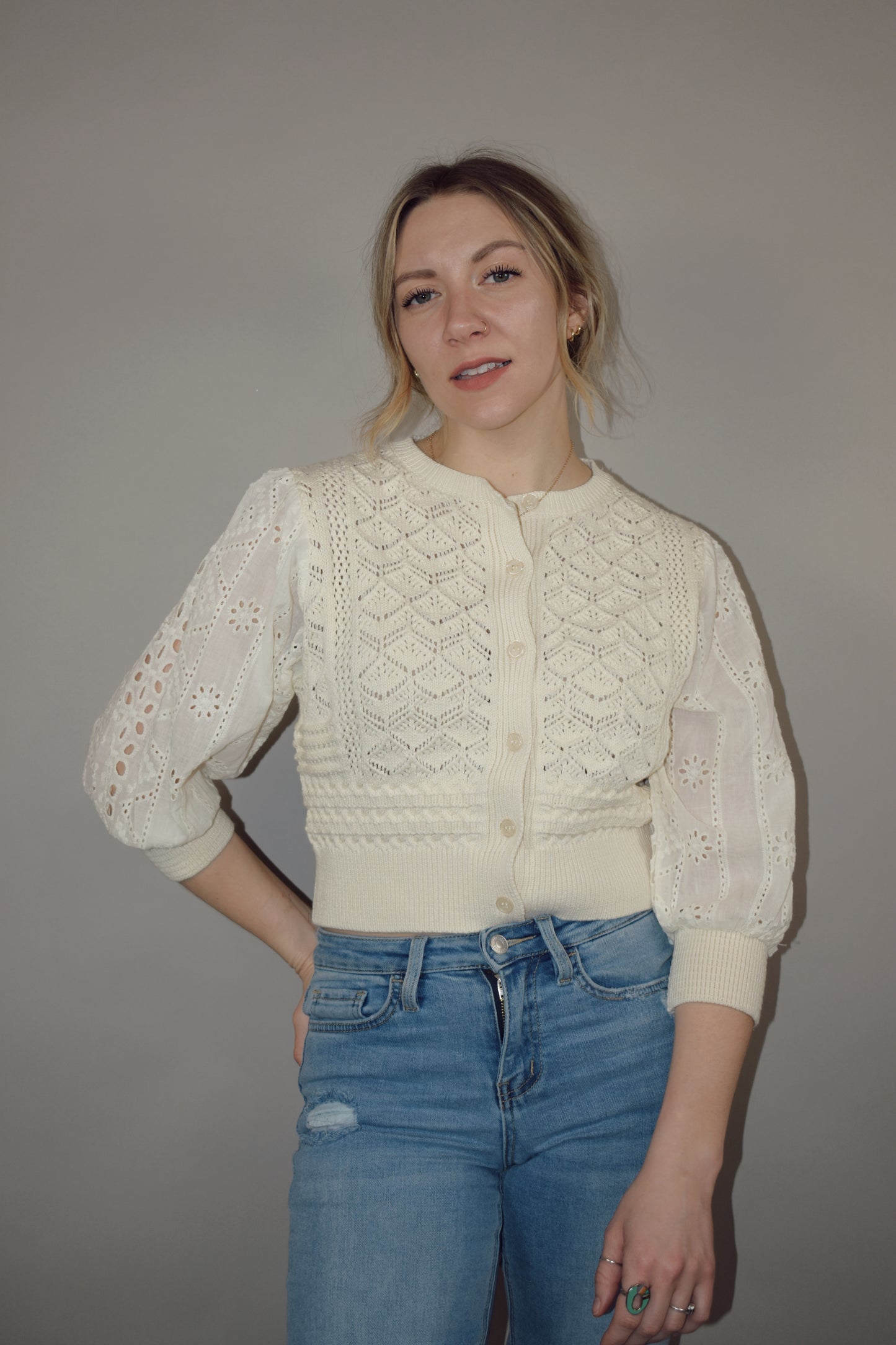 cropped button down top, round neck, 3/4 sleeves, crochet stitching on bodice, lace sleeves, knit cuffs and hem. super charming and unique