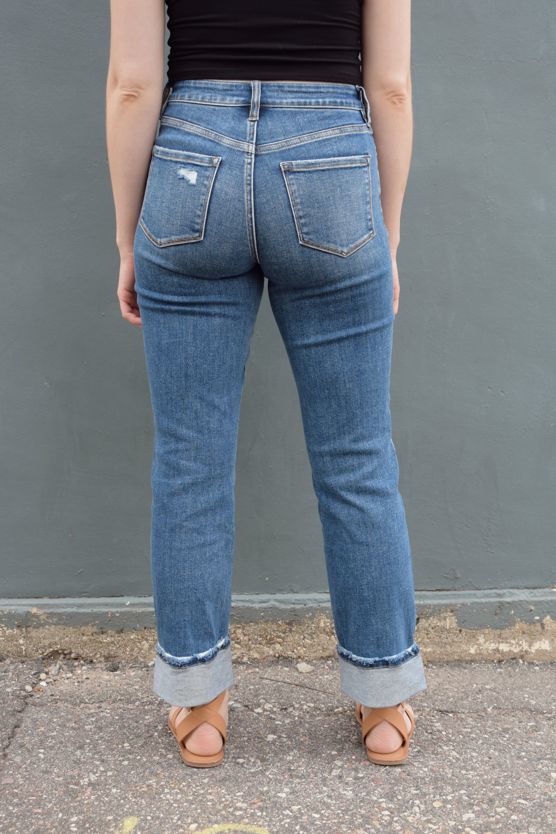 stretch denim straight jeans with cuff that isn't sewn in, zip and button enclosure, no holes, medium wash