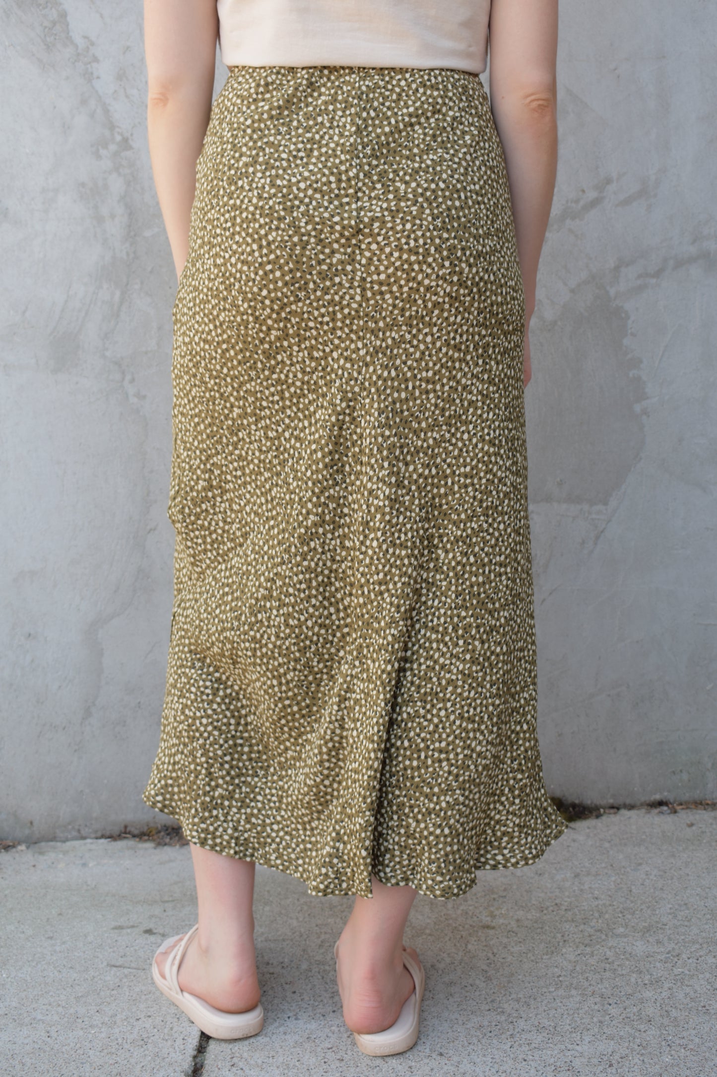 lightweight midi skirt with elastic waistband, no pockets, olive green background with black and cream dotted pattern