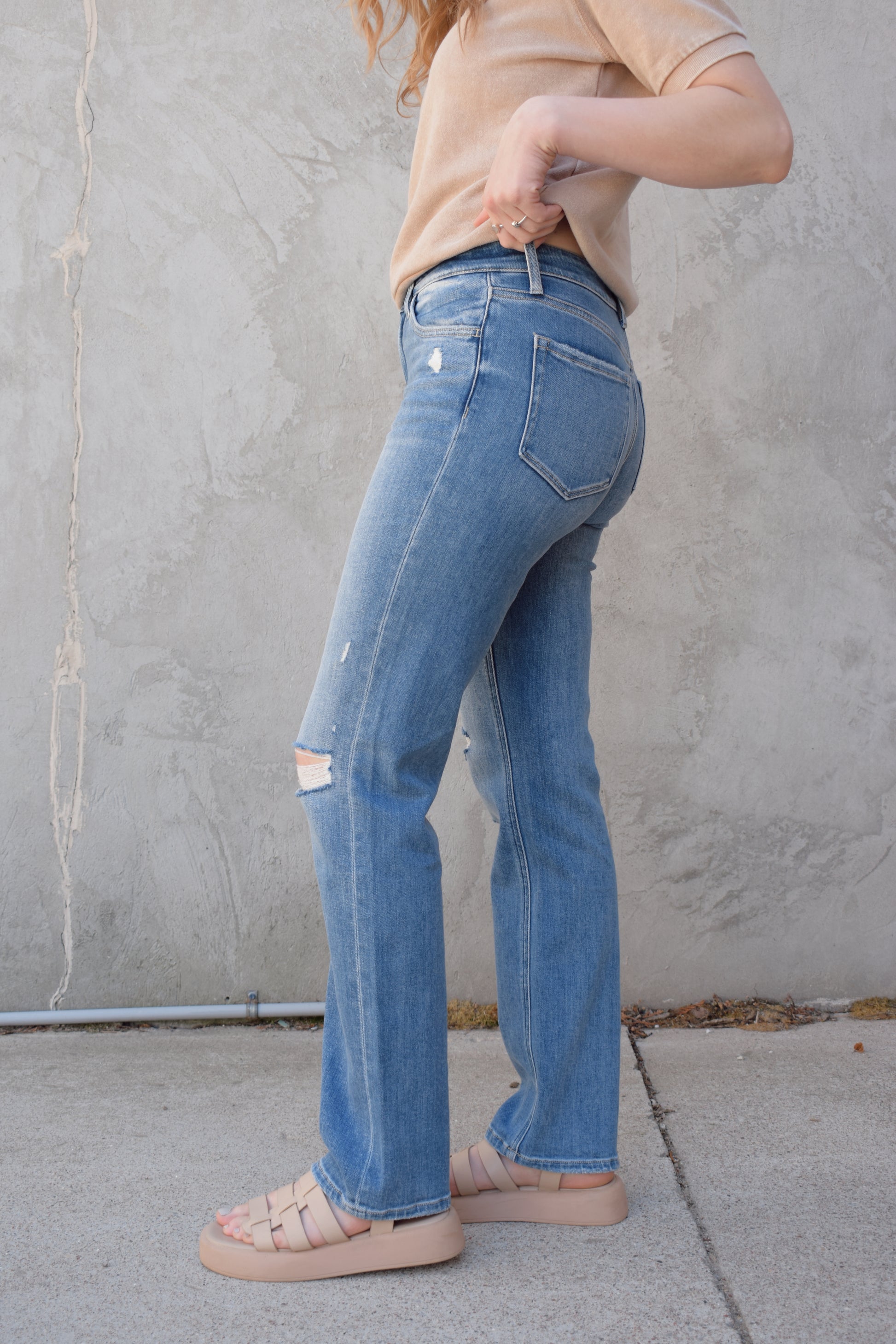 high rise straight jeans medium to light wash with distressing and holes at knees full length high waisted has beltloops stretch denim