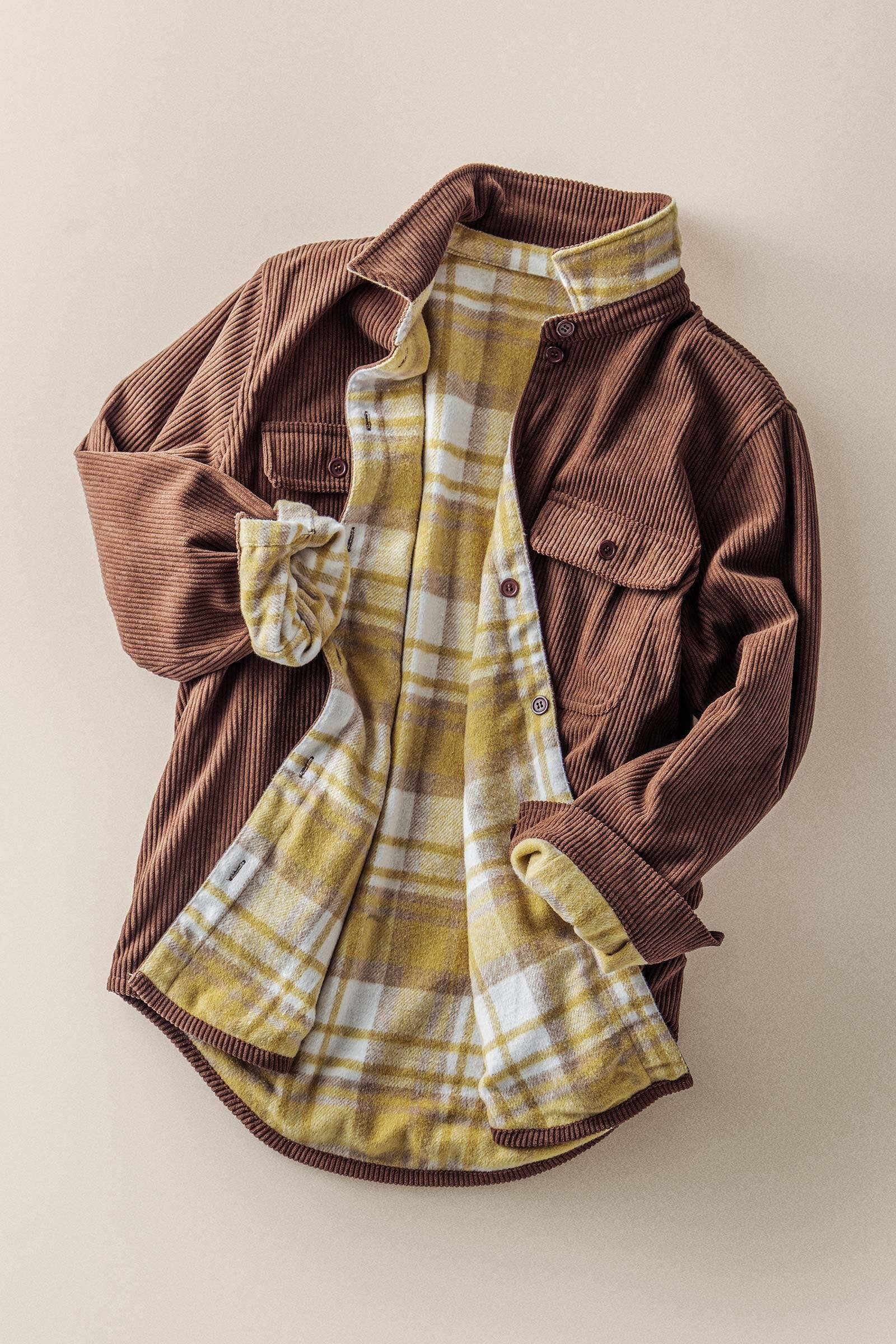 dark brown corduroy shacket lined with mustard color plaid flannel, reversible, one side has breast pockets the other has side front pockets, button down, relaxed fit full length