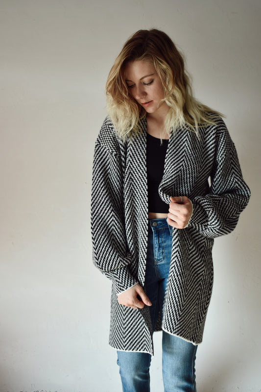 black and white herringbone cardigan open-front design along with a longline silhouette framed with long billowy sleeves