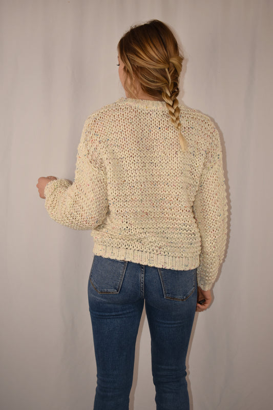 crew neck cable knit sweater full length. loose fit with ivory fabric that has a confetti accent.