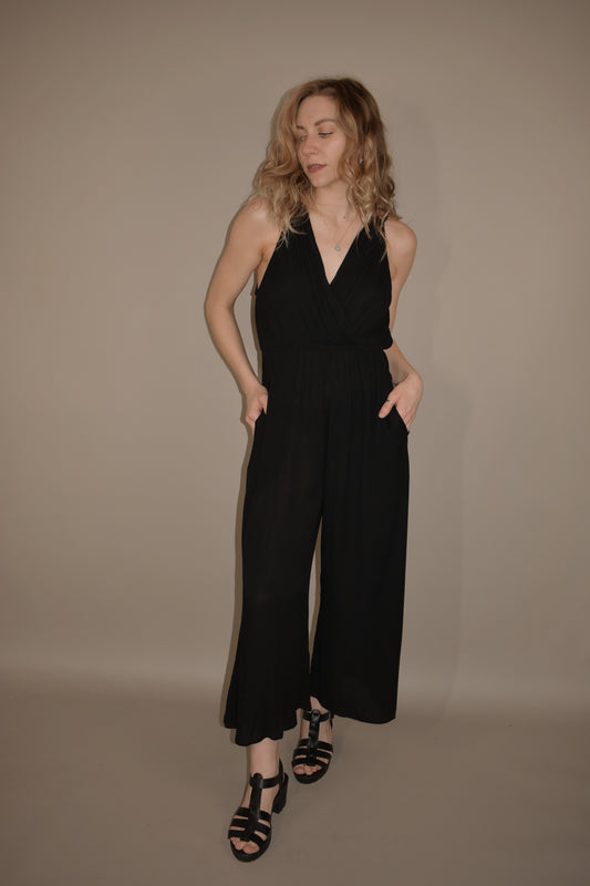 lightweight tank jumpsuit with tie at back of neck. v neck wrap effect front. flowy wide leg. has front pockets. slightly cropped legs.