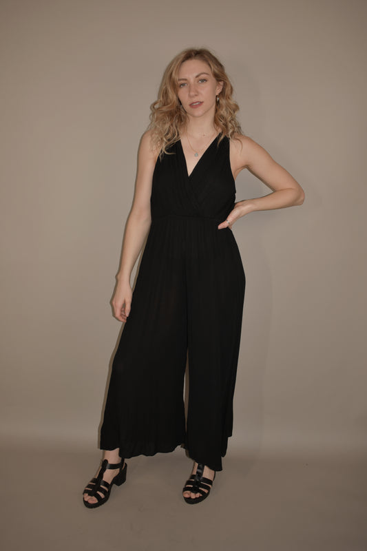 lightweight tank jumpsuit with tie at back of neck. v neck wrap effect front. flowy wide leg. has front pockets. slightly cropped legs.