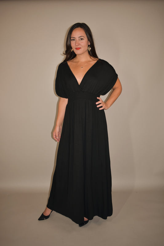 black maxi dress with lightweight flowy fabric. deep v in front and back with smocked fitted waistband. elegant cinched semi wing short sleeves