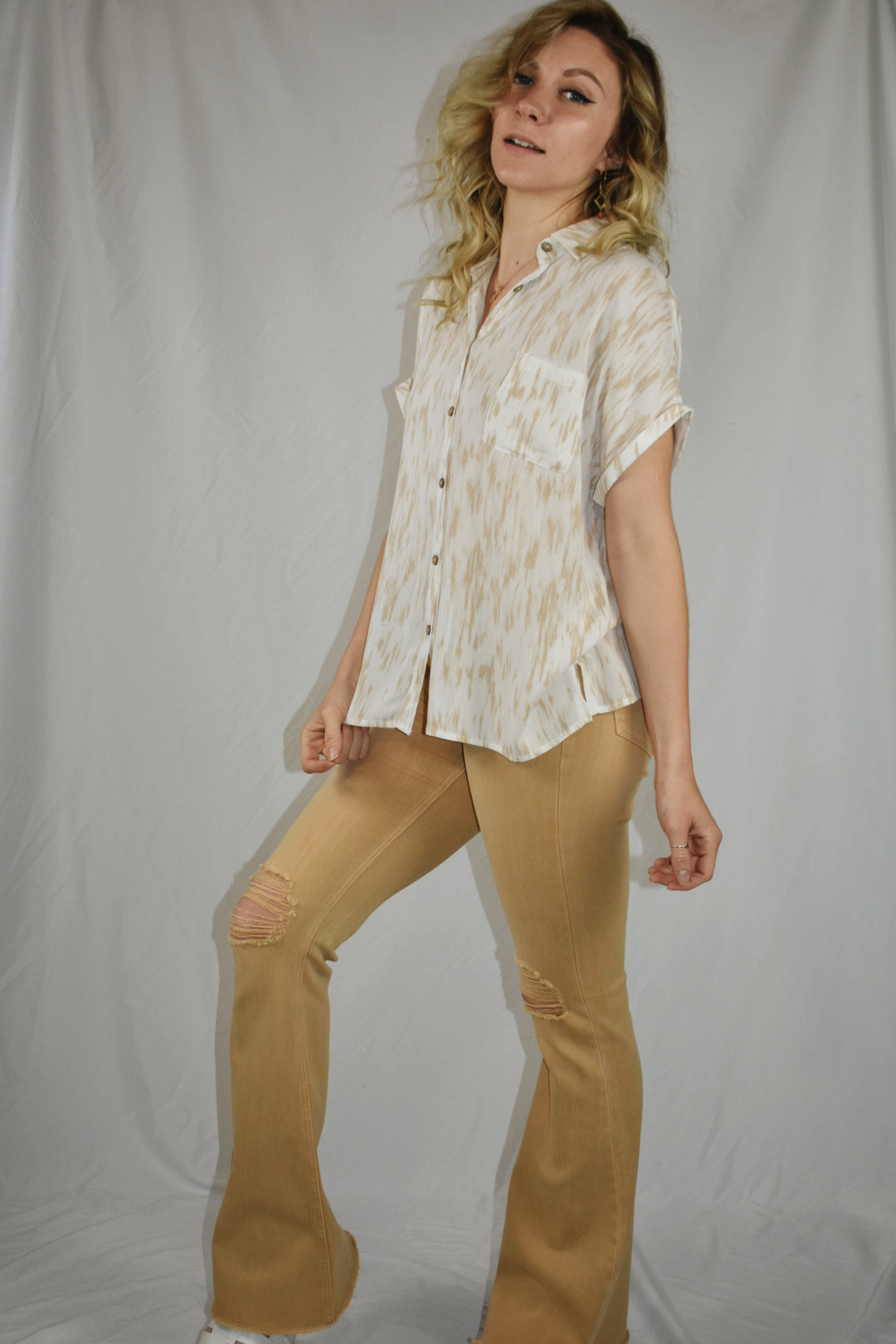 white and tan patterned short sleeve button down with cuffed sleeves slits on side one breast pocket beachy mittoshop the revival