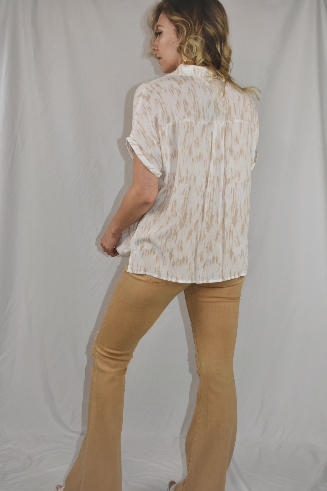 white and tan patterned short sleeve button down with cuffed sleeves slits on side one breast pocket beachy mittoshop the revival