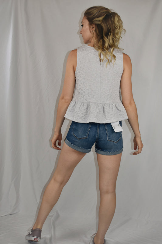 daisy textured jacquard top keyhole back with button and a ruffle hem at the bottom Mittoshop the revival