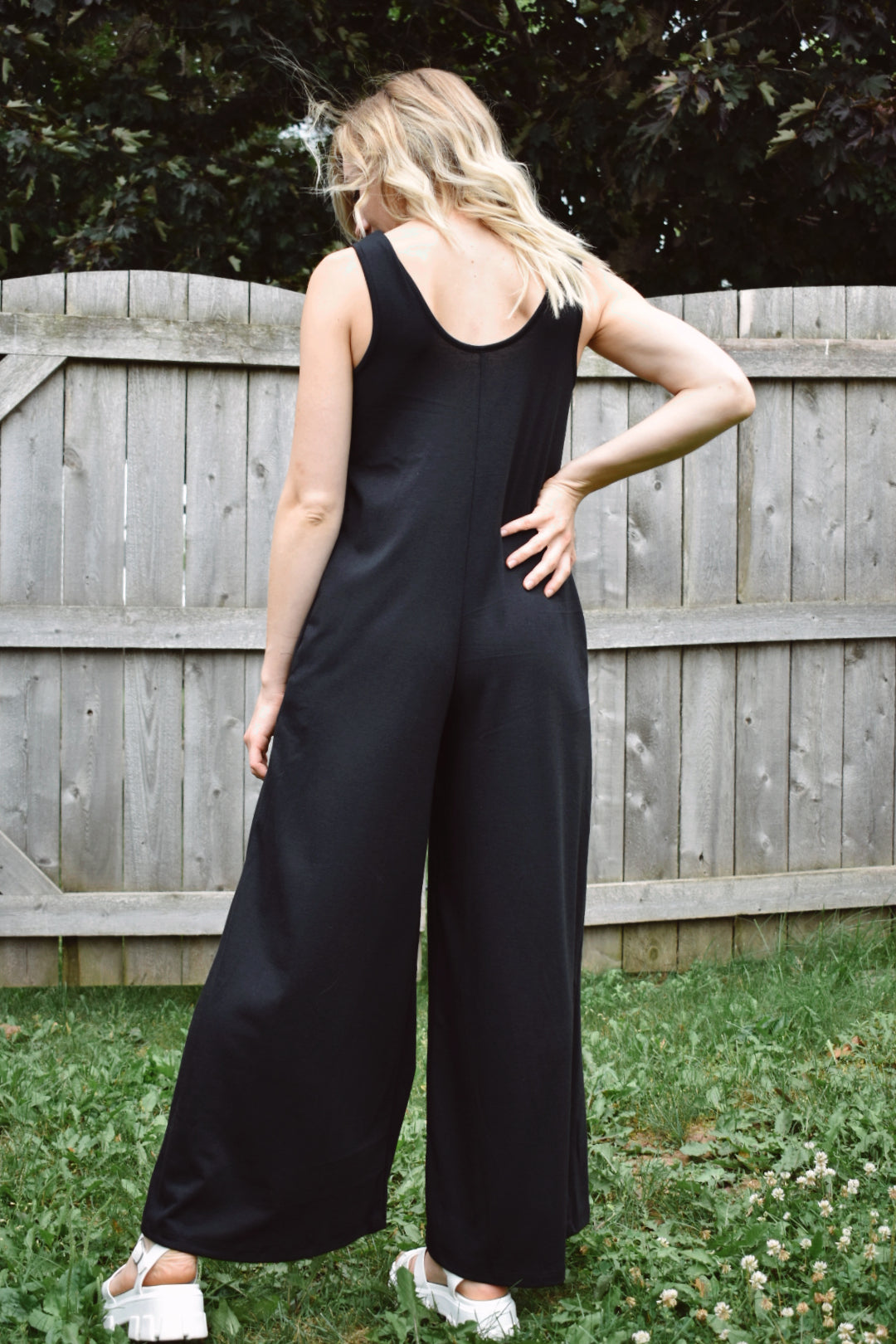 scoop neck tank jumpsuit in black with wide legs and pockets. Made with french terry knit fabric and is loose fitting. The brand is Mittoshop.