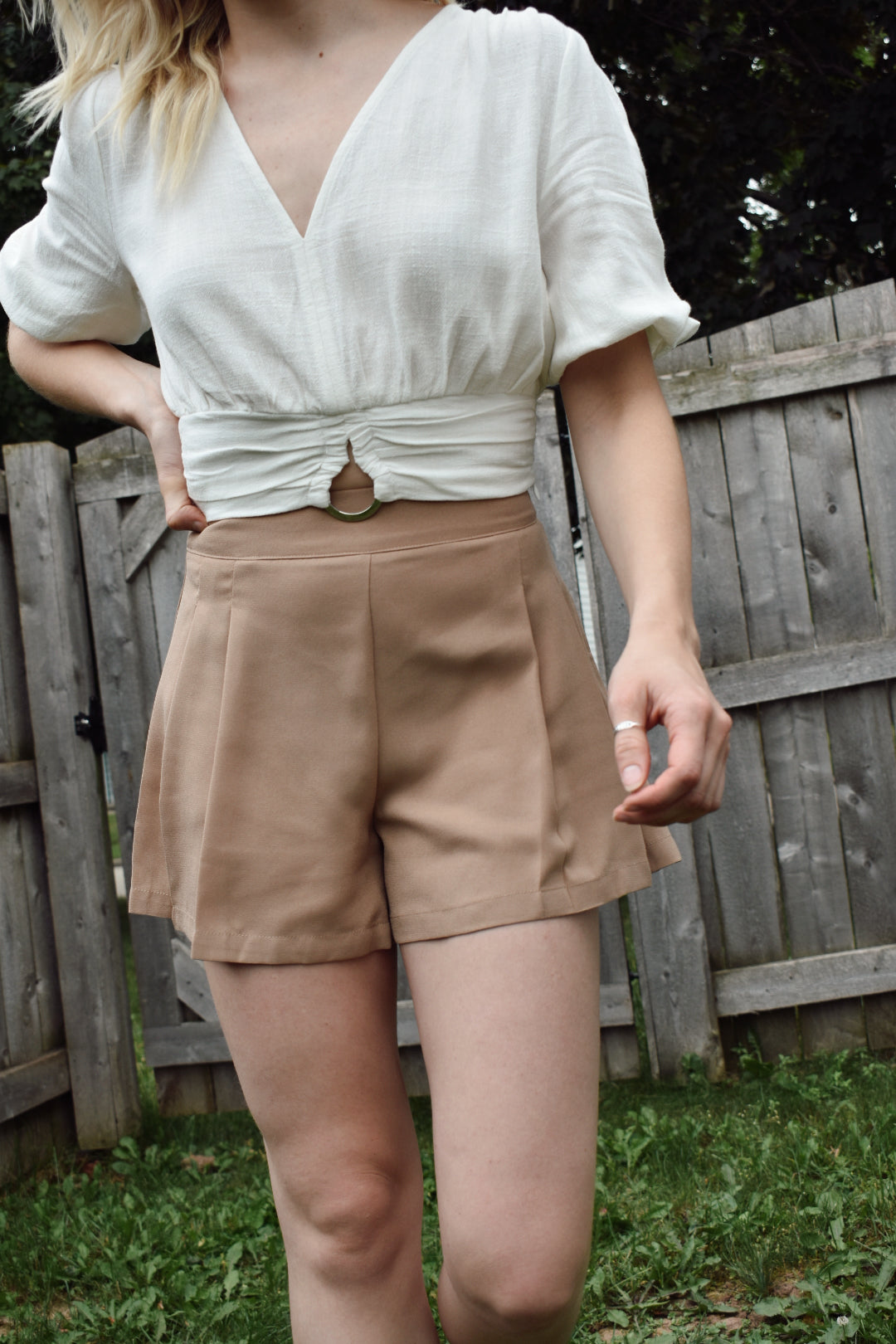 High waisted mocha pleated dress shorts with zipper enclosure on side fitted band on top. The brand is Mittoshop.