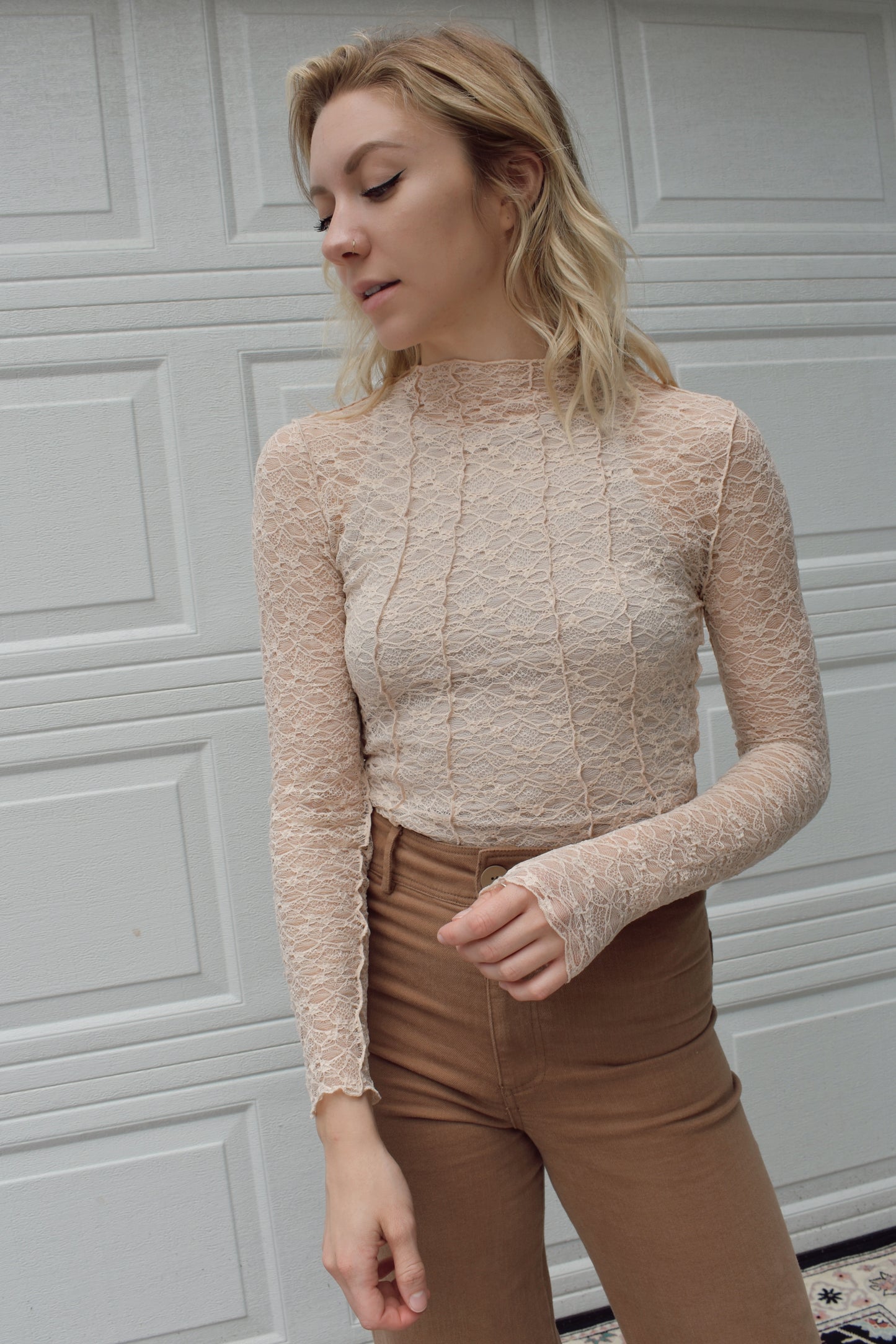 Illa Illa. Mod neck long sleeve sheer nude lace top with exposed seam detail along the front and back. Full length.