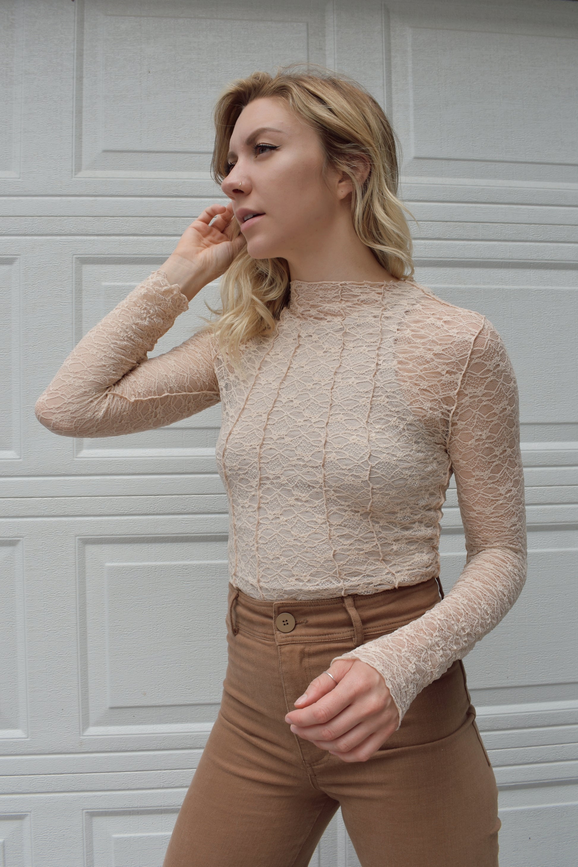 Illa Illa. Mod neck long sleeve sheer nude lace top with exposed seam detail along the front and back. Full length.
