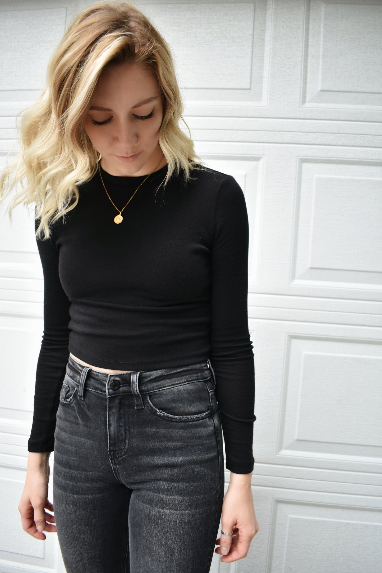 black long steeve essential fitted cropped top with round neck. Stretchy, comfortable, the brand is Hyfve.