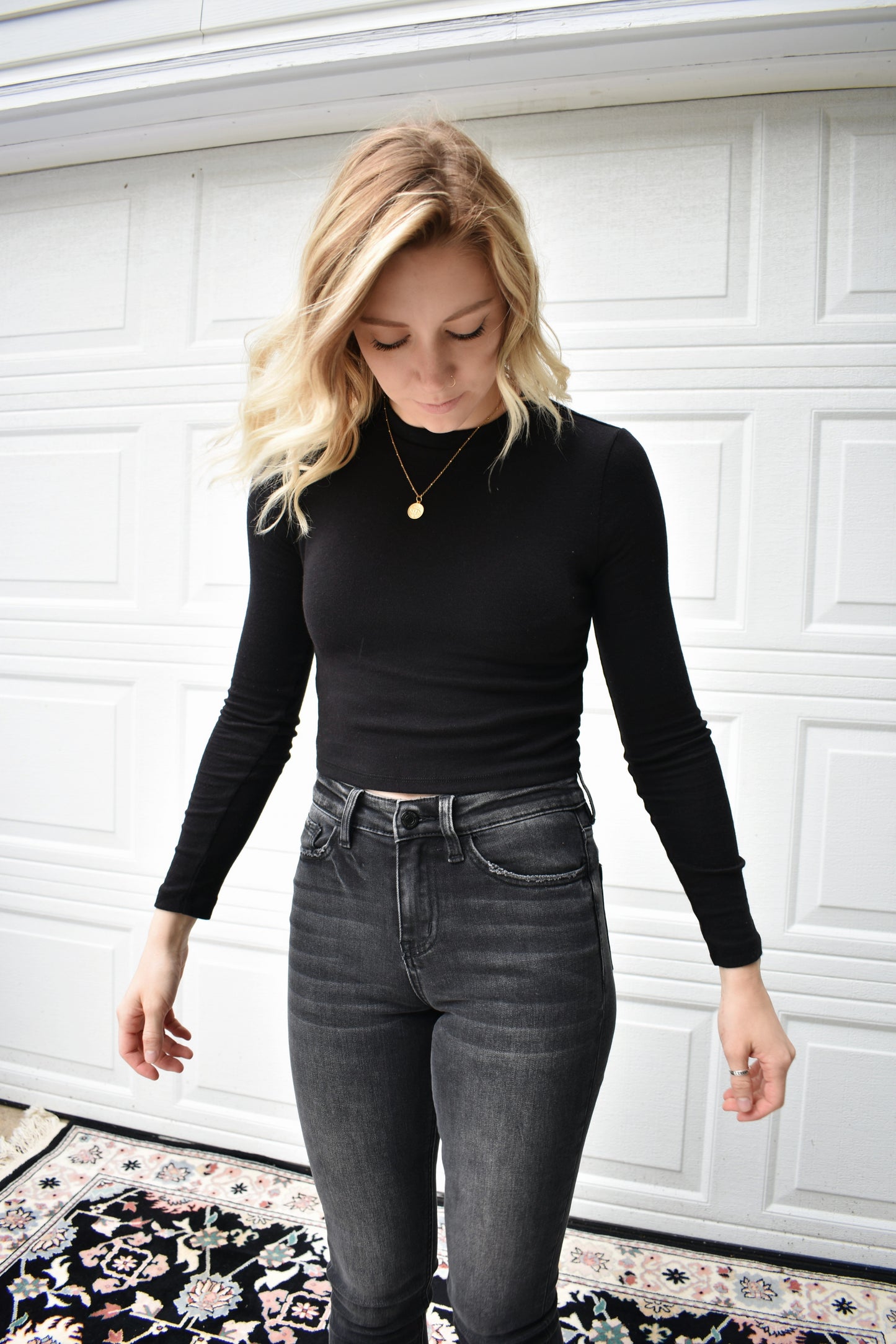 black long steeve essential fitted cropped top with round neck. Stretchy, comfortable, the brand is Hyfve.