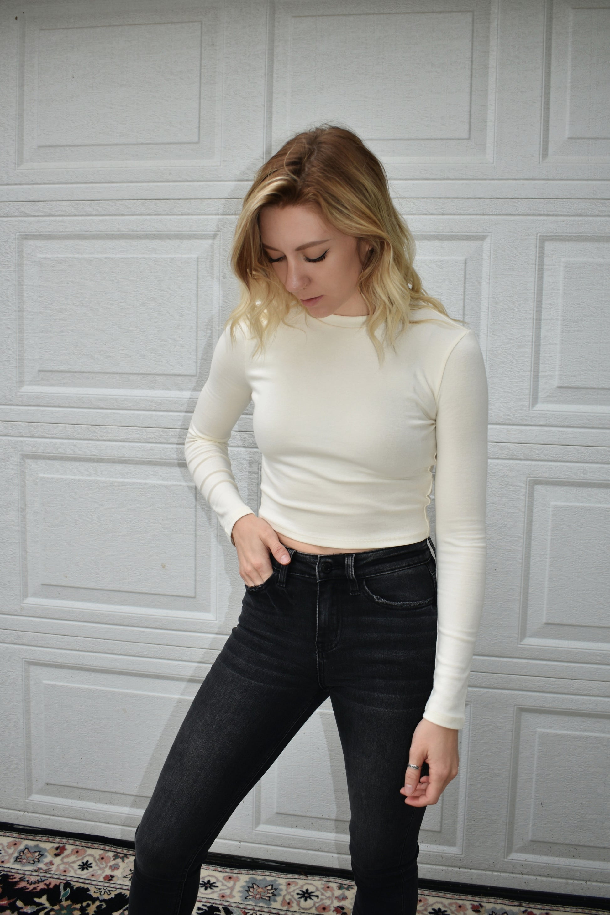 cream long steeve essential fitted cropped top with round neck. Stretchy, comfortable, the brand is Hyfve.