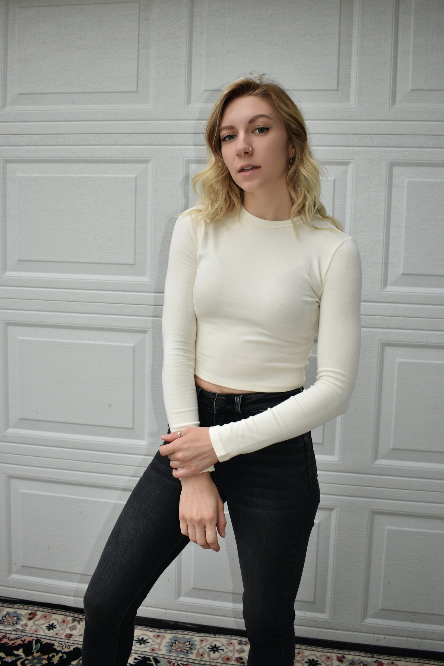 cream long steeve essential fitted cropped top with round neck. Stretchy, comfortable, the brand is Hyfve.