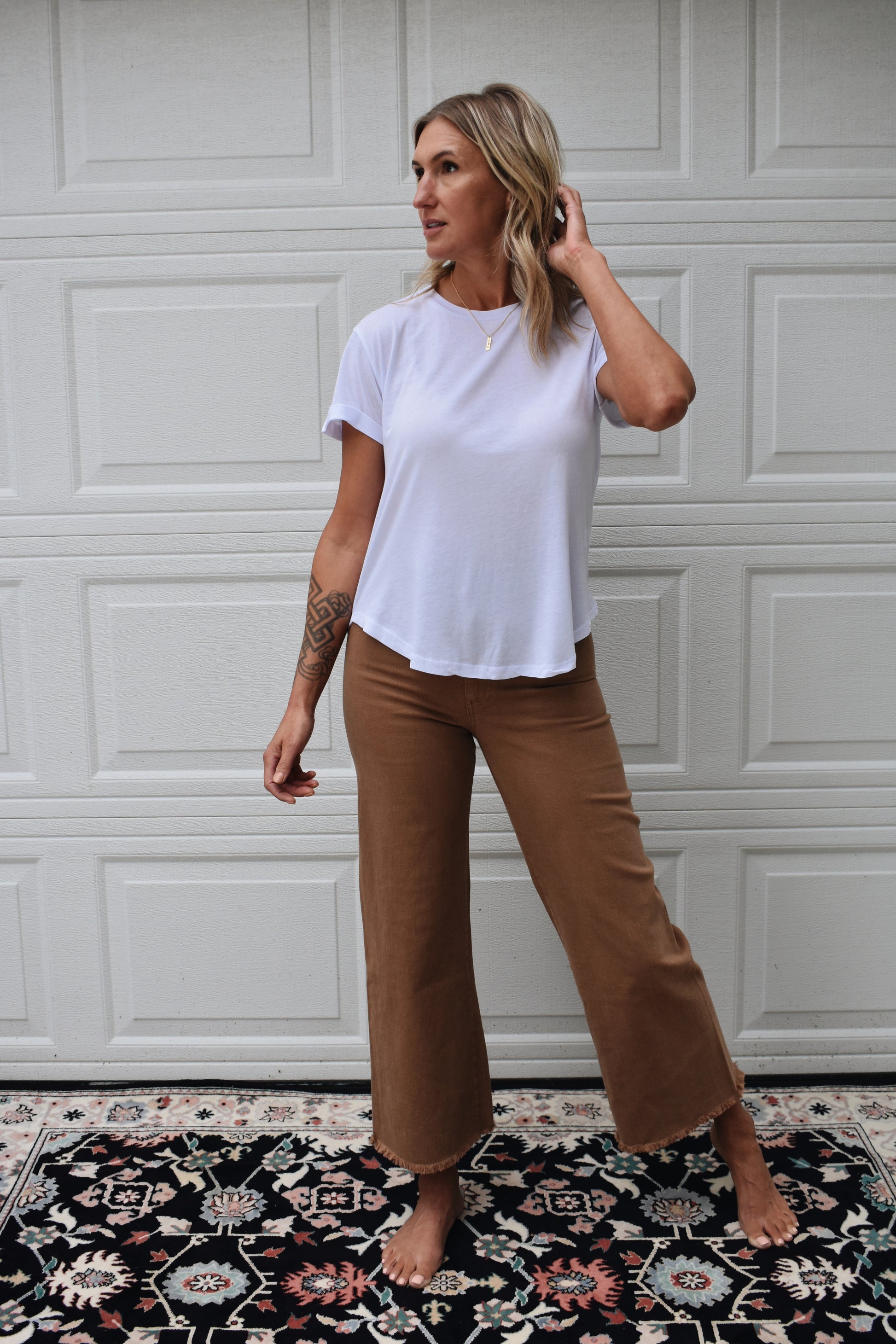 loose fitted white tee with cuffed sleeves and round neckline. super soft fabric. full length.