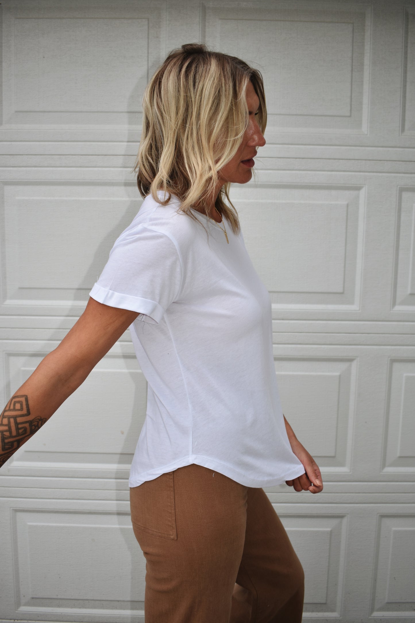 loose fitted white tee with cuffed sleeves and round neckline. super soft fabric. full length.