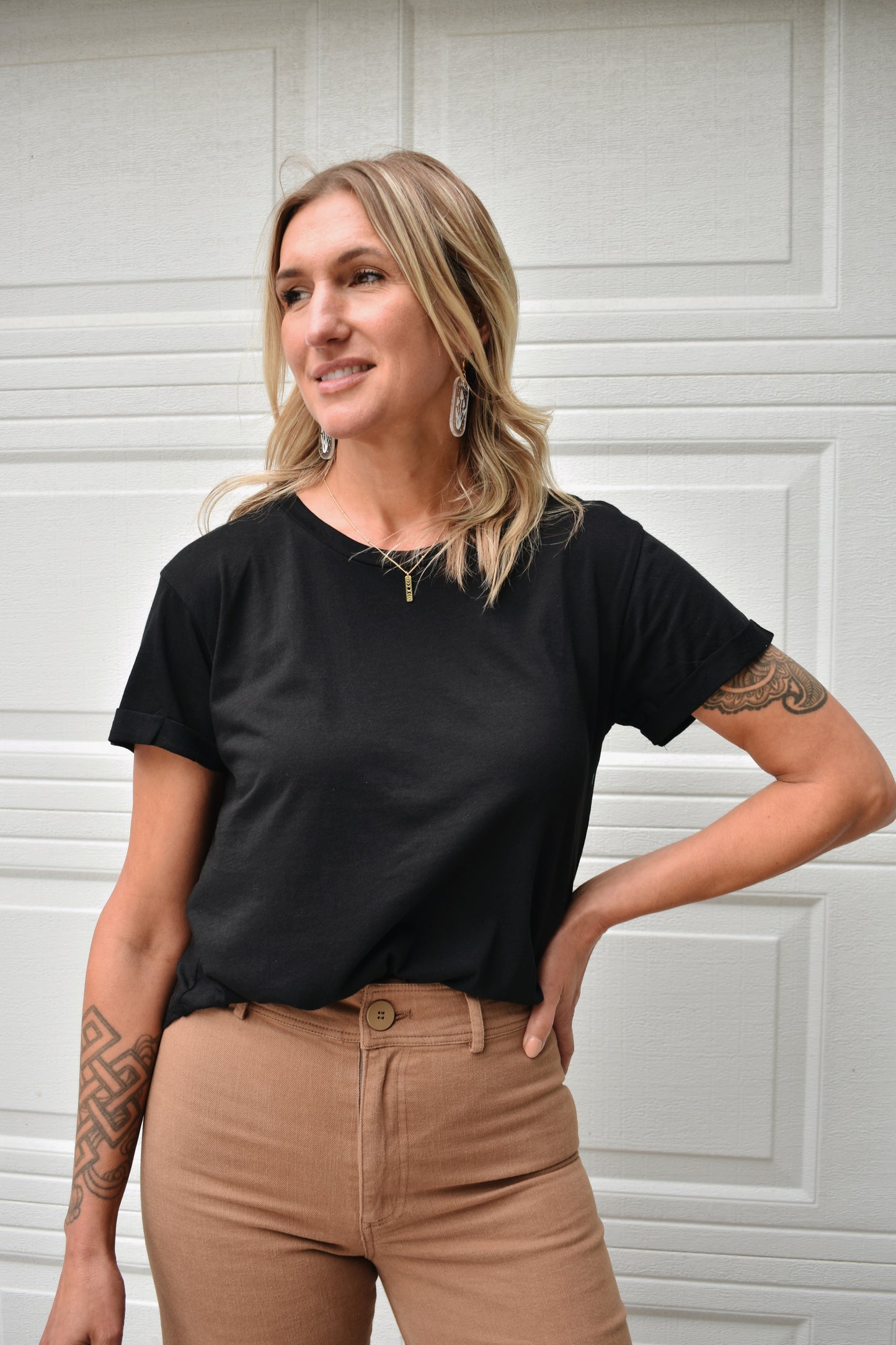 loose fitted black tee with cuffed sleeves and round neckline. super soft fabric. full length.