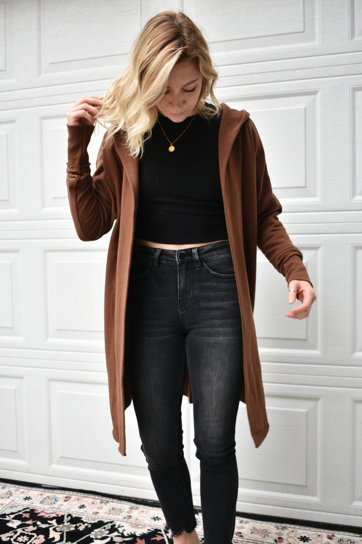 Cocoa colored hooded jersey cardigan with wide cuffed sleeves, an open front, and pockets. fleece lining. 100% cotton