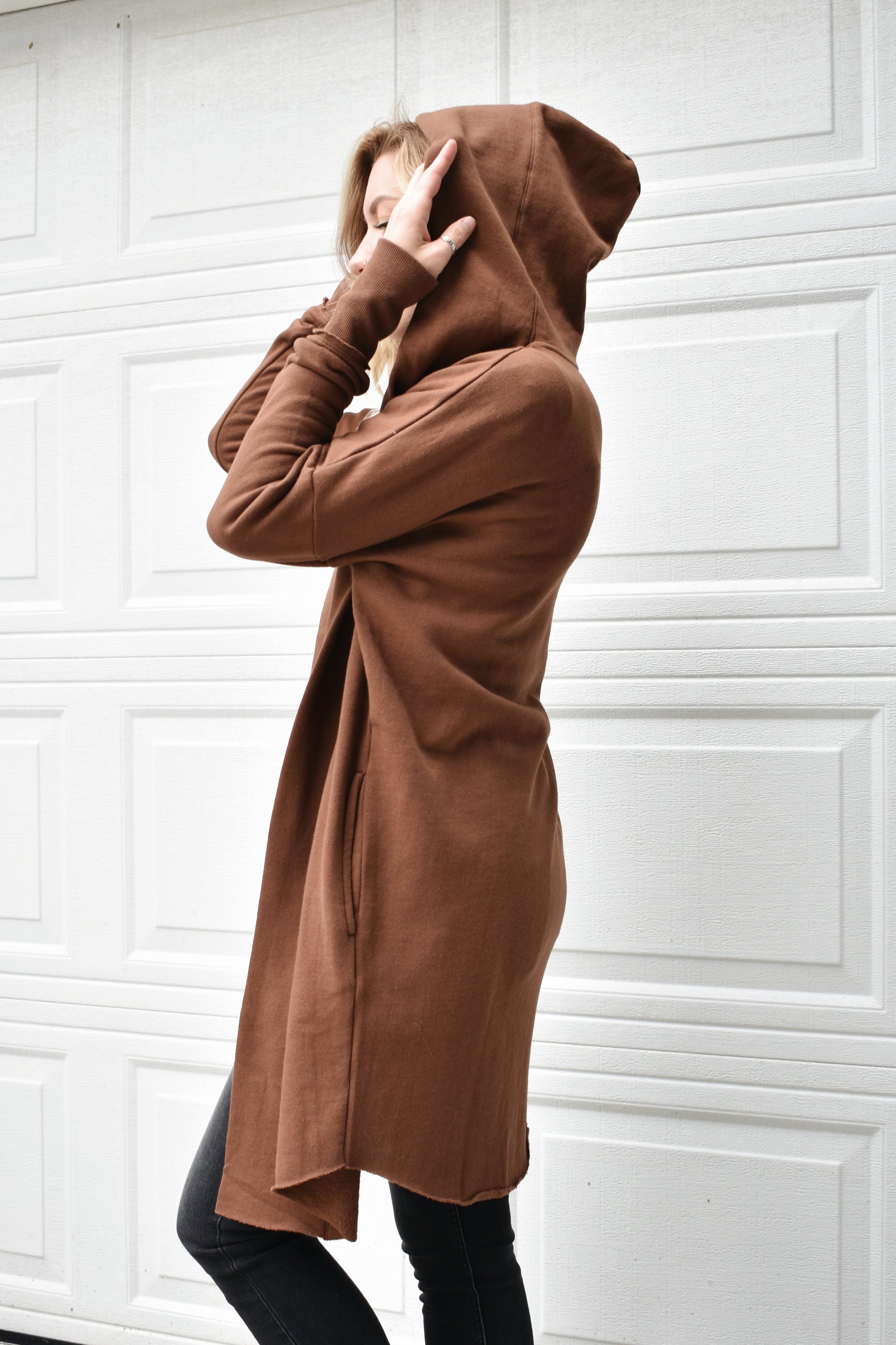 Cocoa colored hooded jersey cardigan with wide cuffed sleeves, an open front, and pockets. fleece lining. 100% cotton