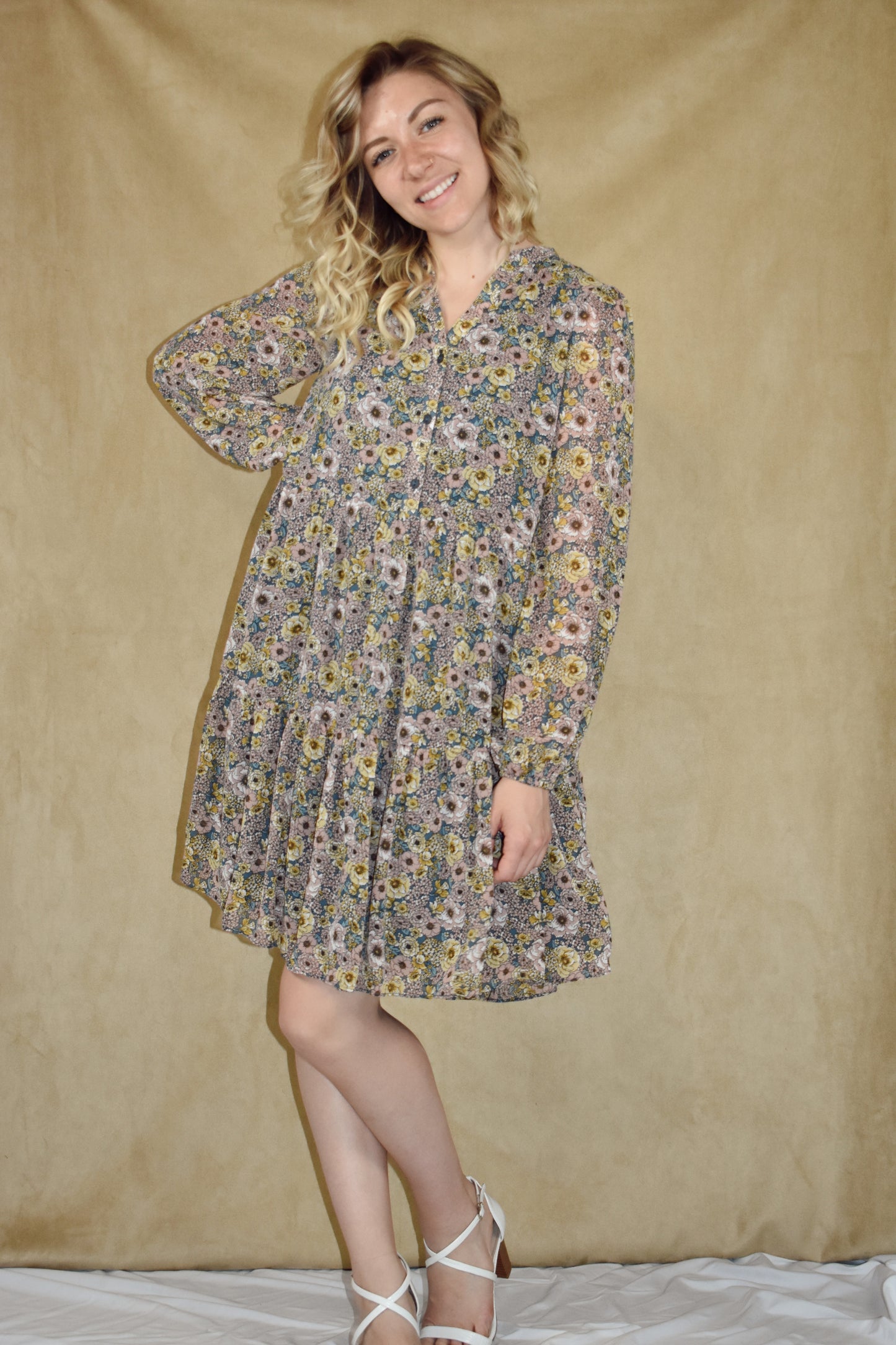 long sleeve mini dress loose fitted, vintage floral pattern, round neckline, slit front and placket with button front closure. ruffle tier skirt