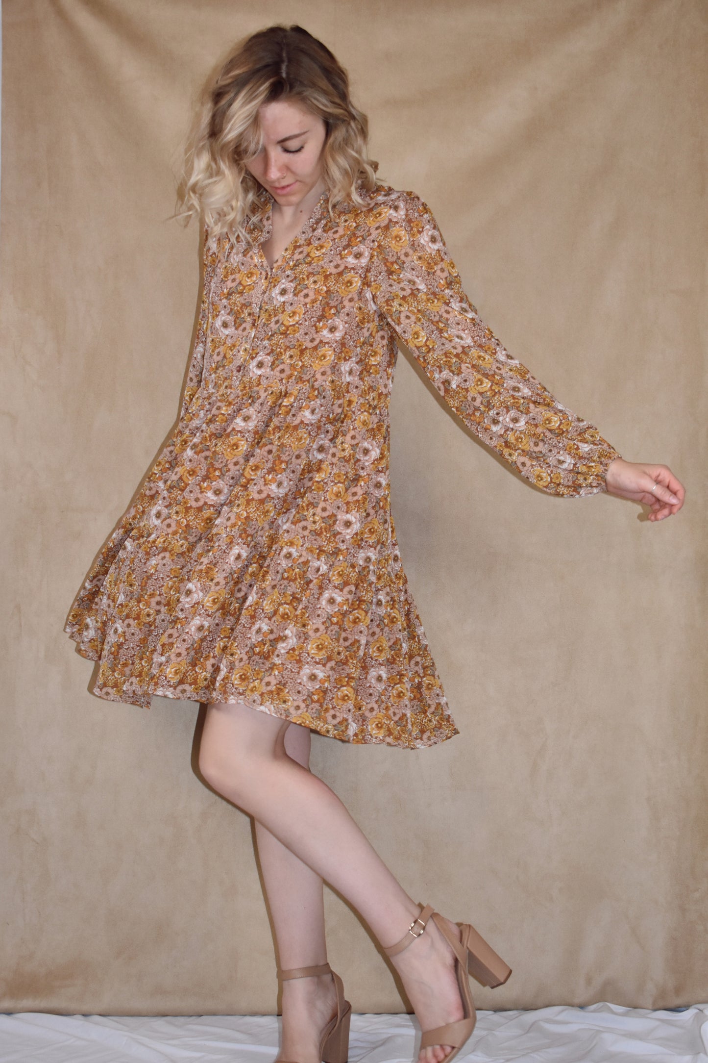 long sleeve mini dress loose fitted, vintage floral pattern, round neckline, slit front and placket with button front closure. ruffle tier skirt
