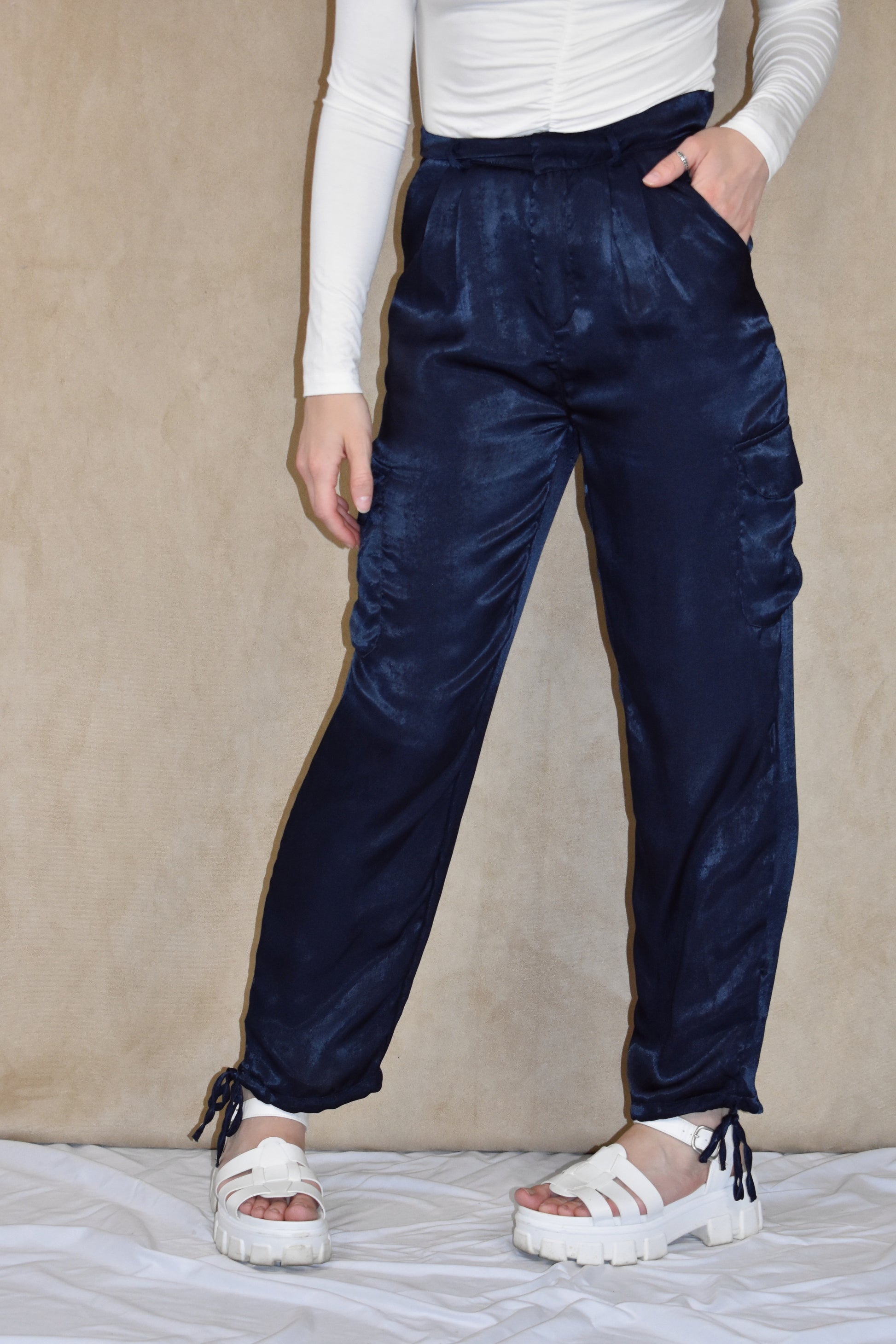 dark blue satin cargo pants. side pockets with top flap and drawstring on the bottom.