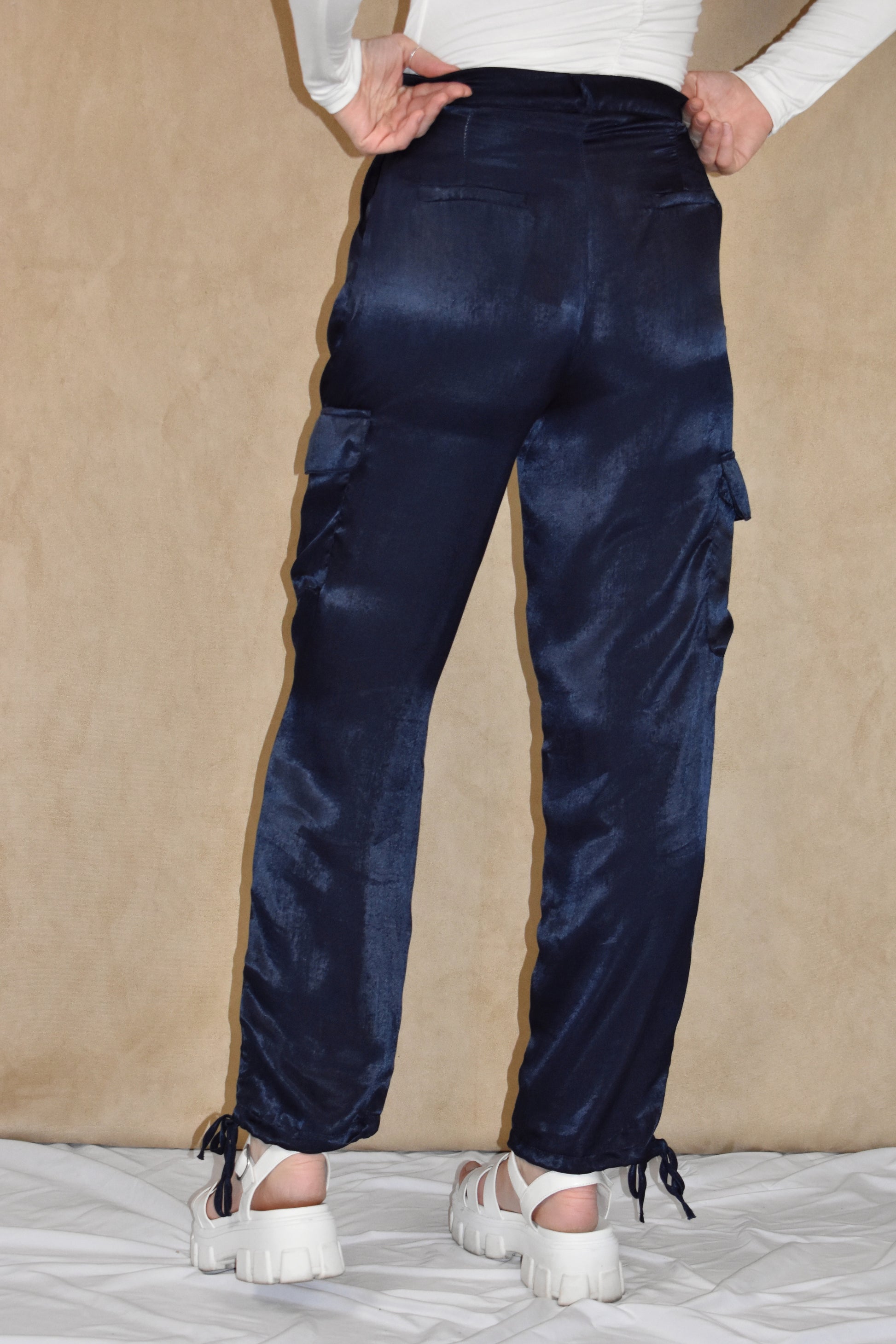 dark blue satin cargo pants. side pockets with top flap and drawstring on the bottom.