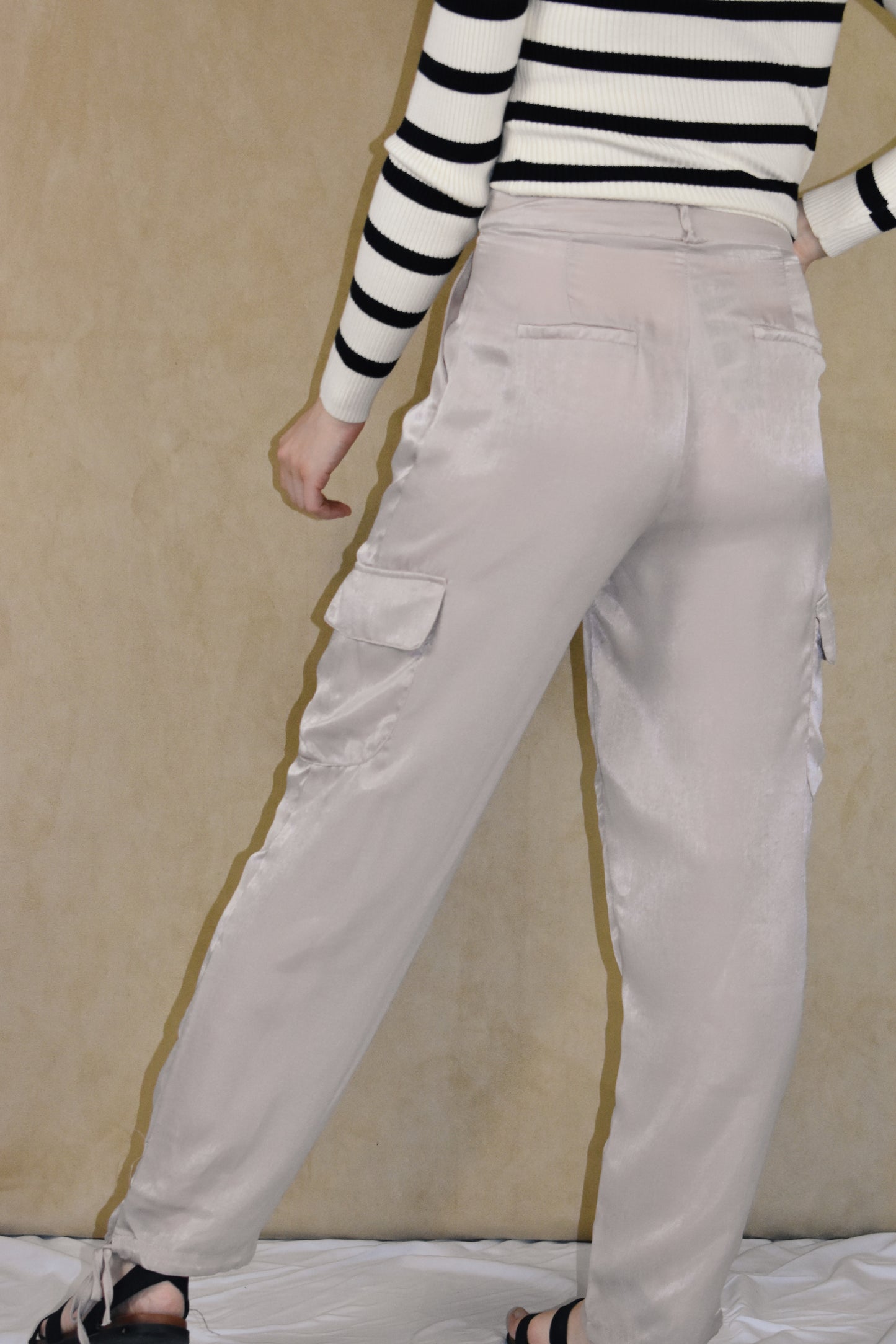 dusty rose satin cargo pants. side pockets with top flap and drawstring on the bottom.