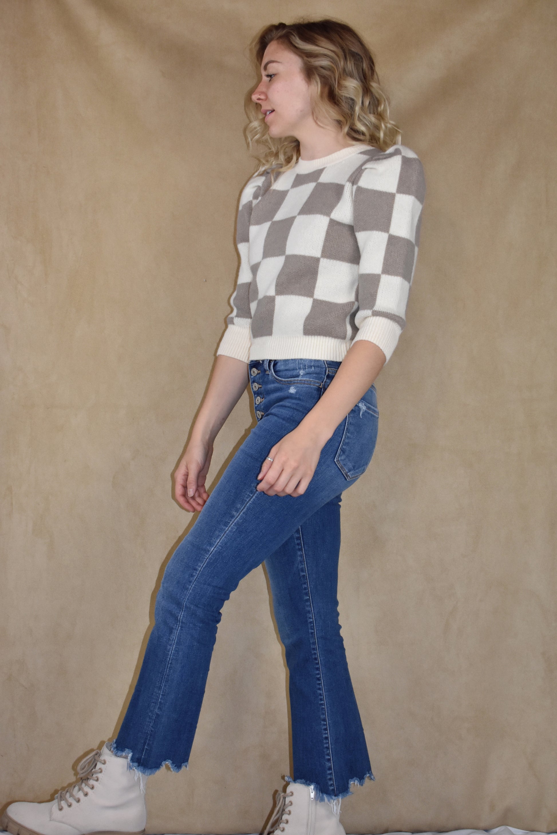 checkered ivory and taupe sweater with ribbed crew neckline, hem, and cuffs. Puff shoulders and elbow length sleeves. 