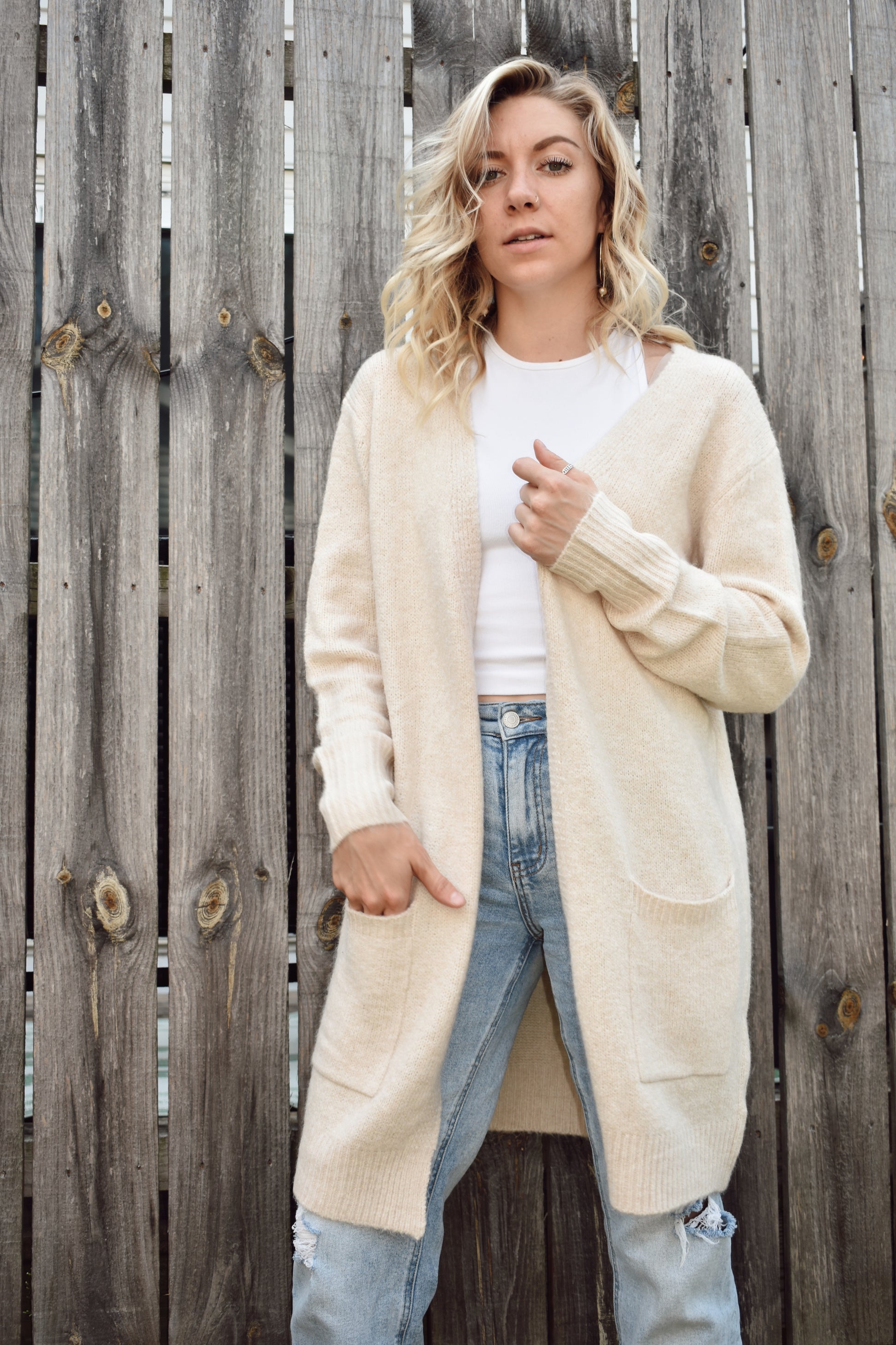 Open front knit cardigan in a natural color hits just above the knees and has two front patch pockets super cozy 