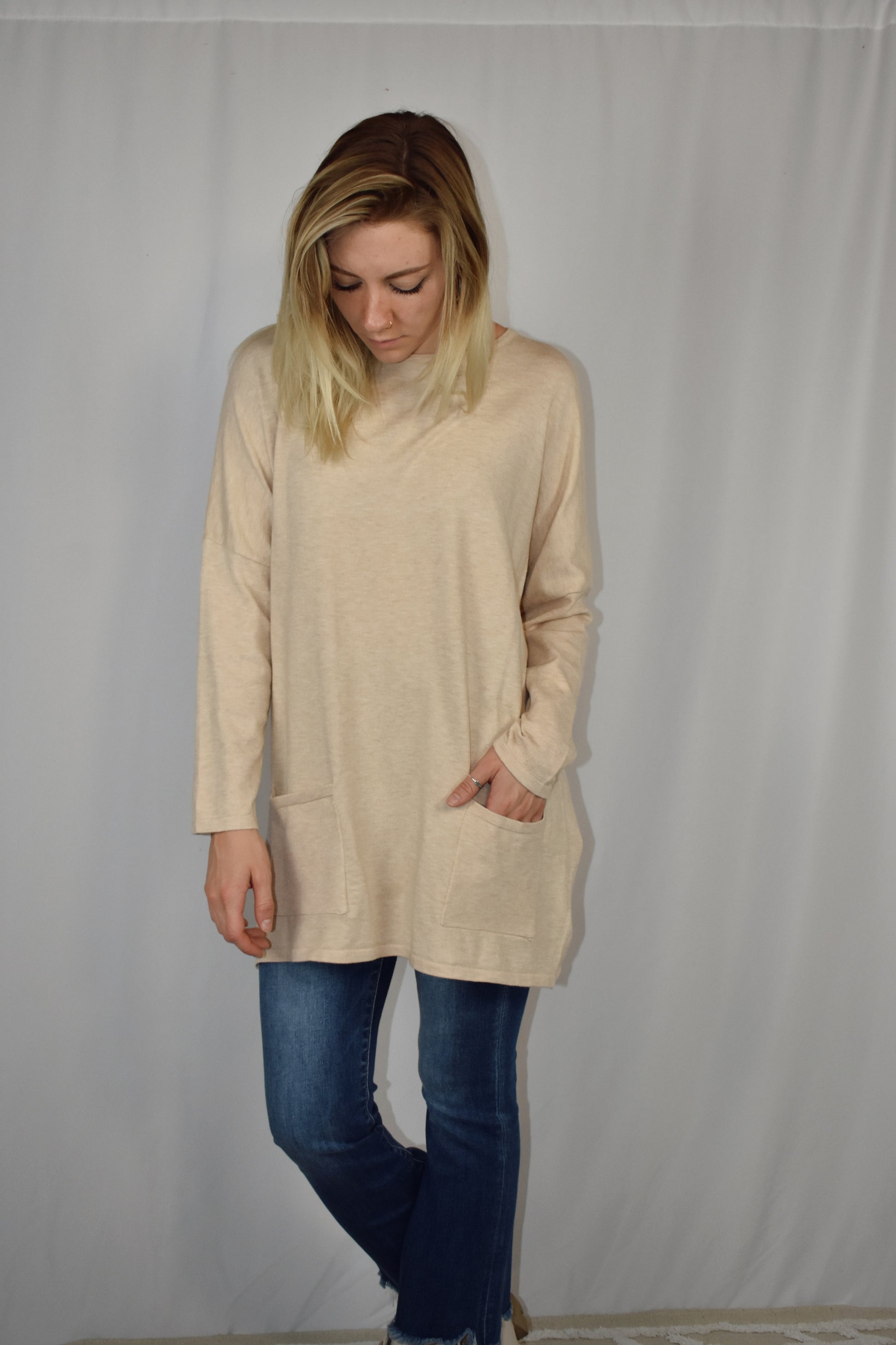 Oversized oatmeal colored sweater, lightweight fabric, scoop neck, front patch pockets, drop shoulders.
