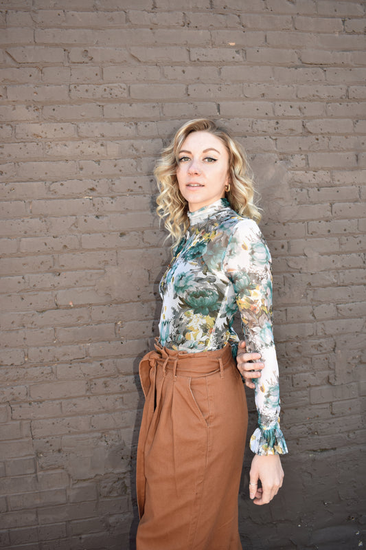 Sheer floral mesh long sleeve top, full length with mock neckline and ruffle cuffs. Blue, yellow, white, green color scheme.