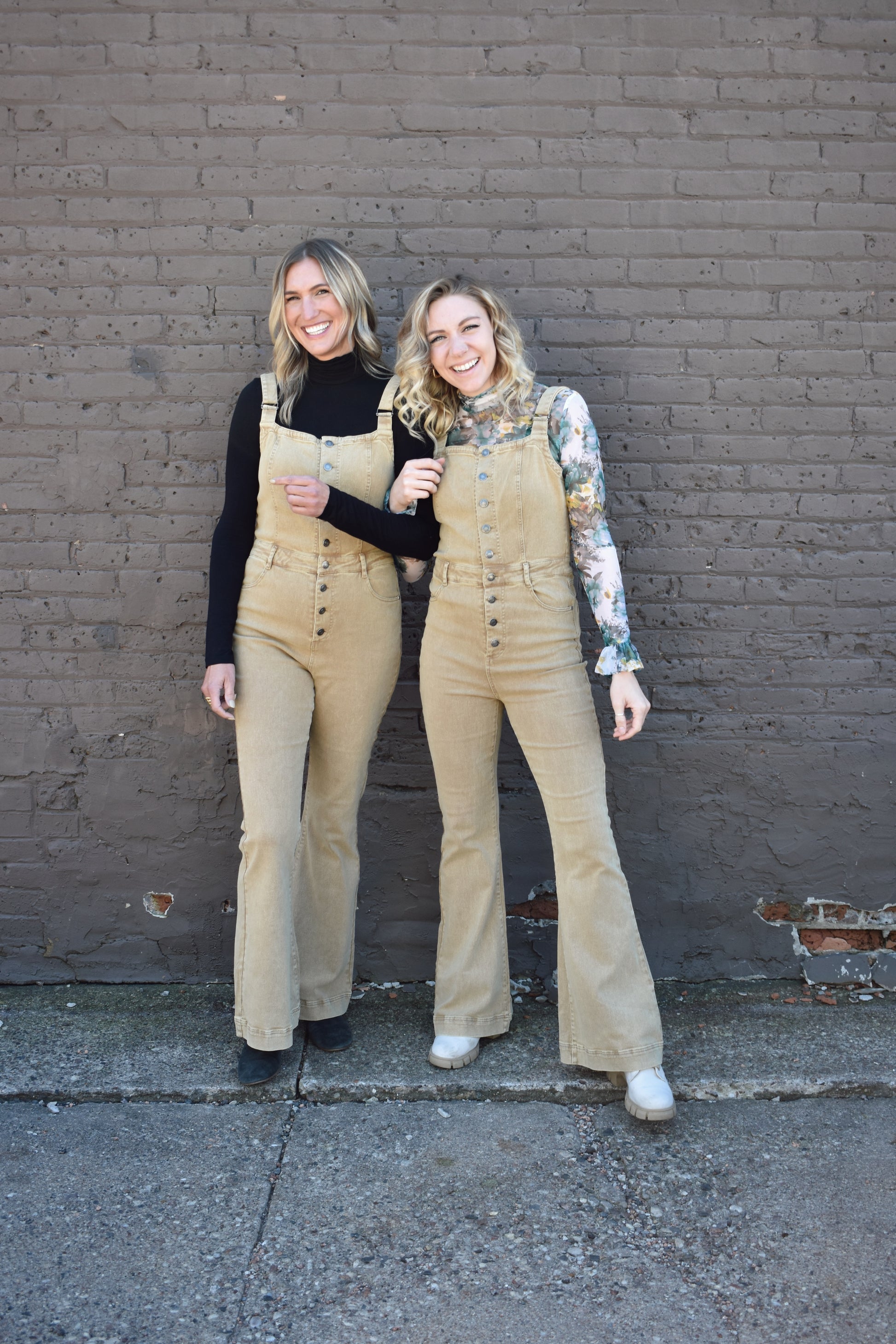 tan fitted denim overalls with bell bottoms and buttons down the front. waistline band has beltloops and front and back pockets. Adjustable straps.