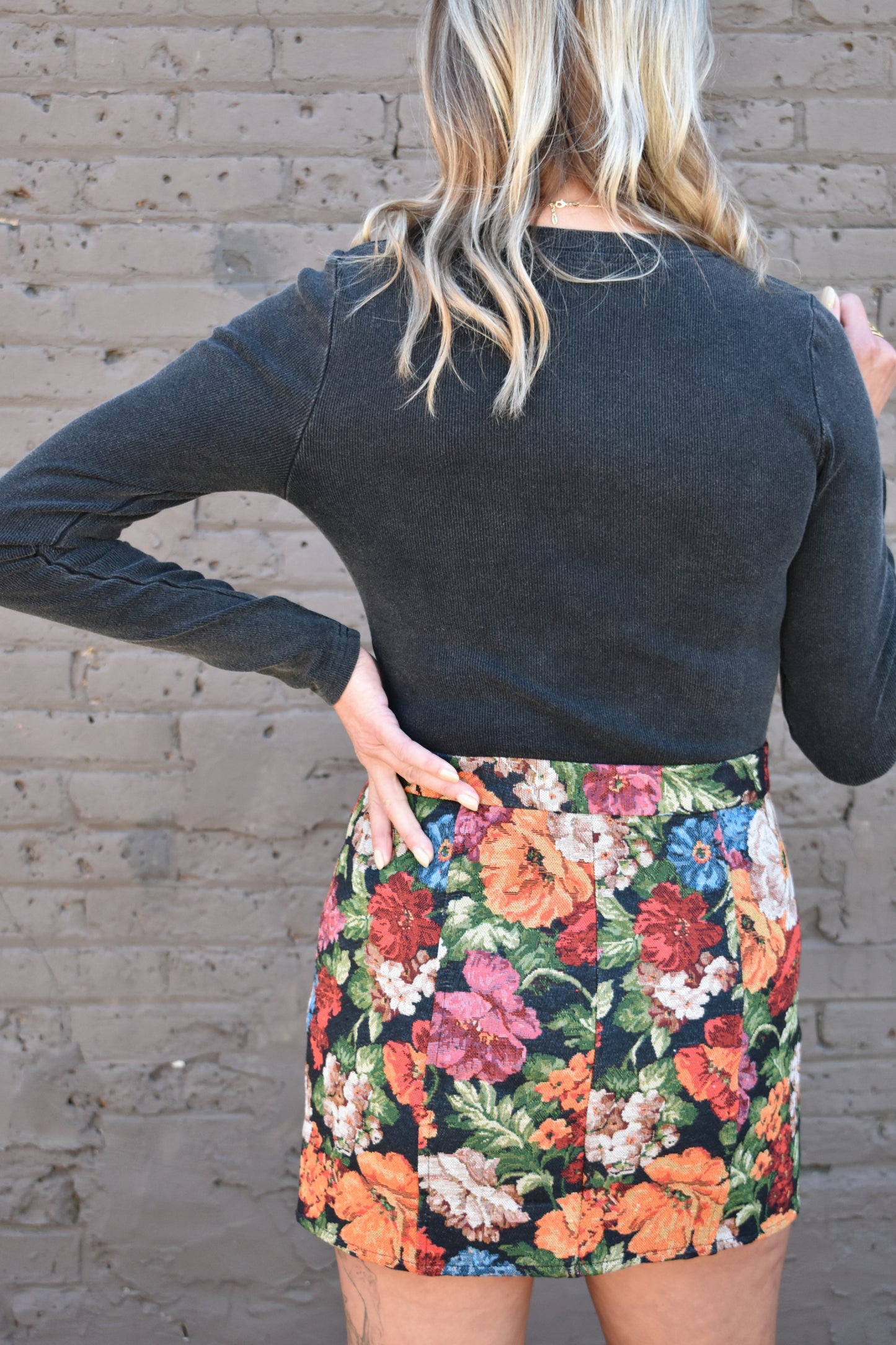 multicolored floral tapestry mini skirt. retro style. black background.