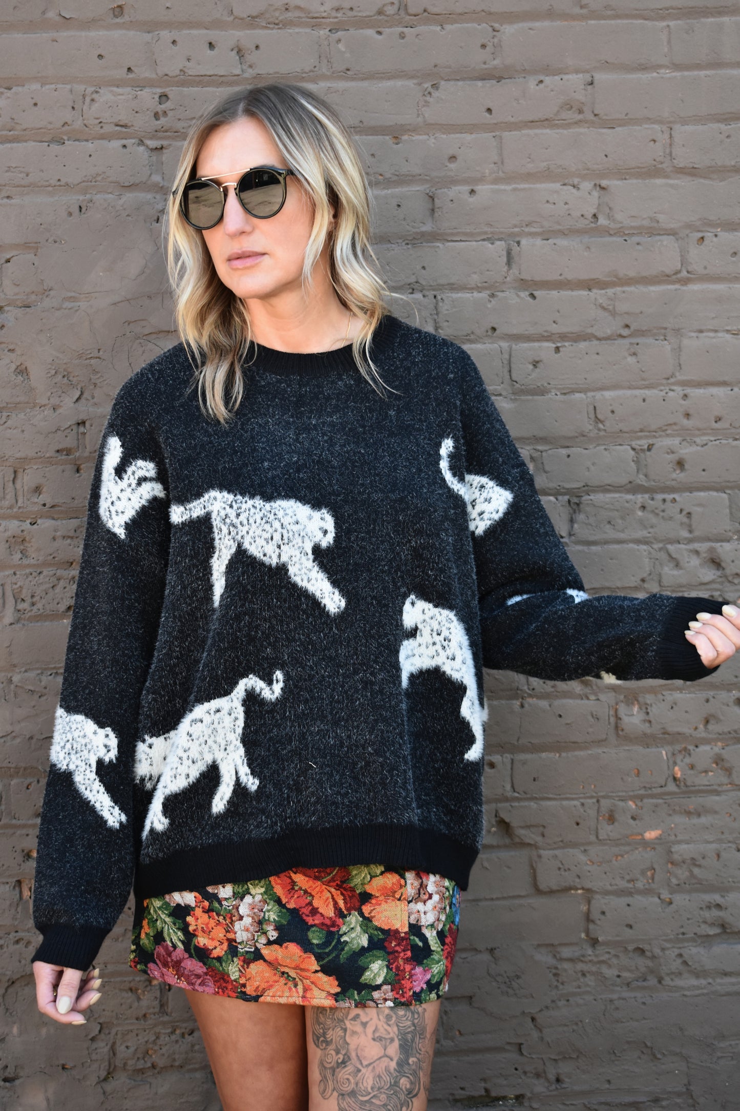 black long sleeve relaxed fit leopard body printed sweater with ribbed crewneck and cuffs. full length.