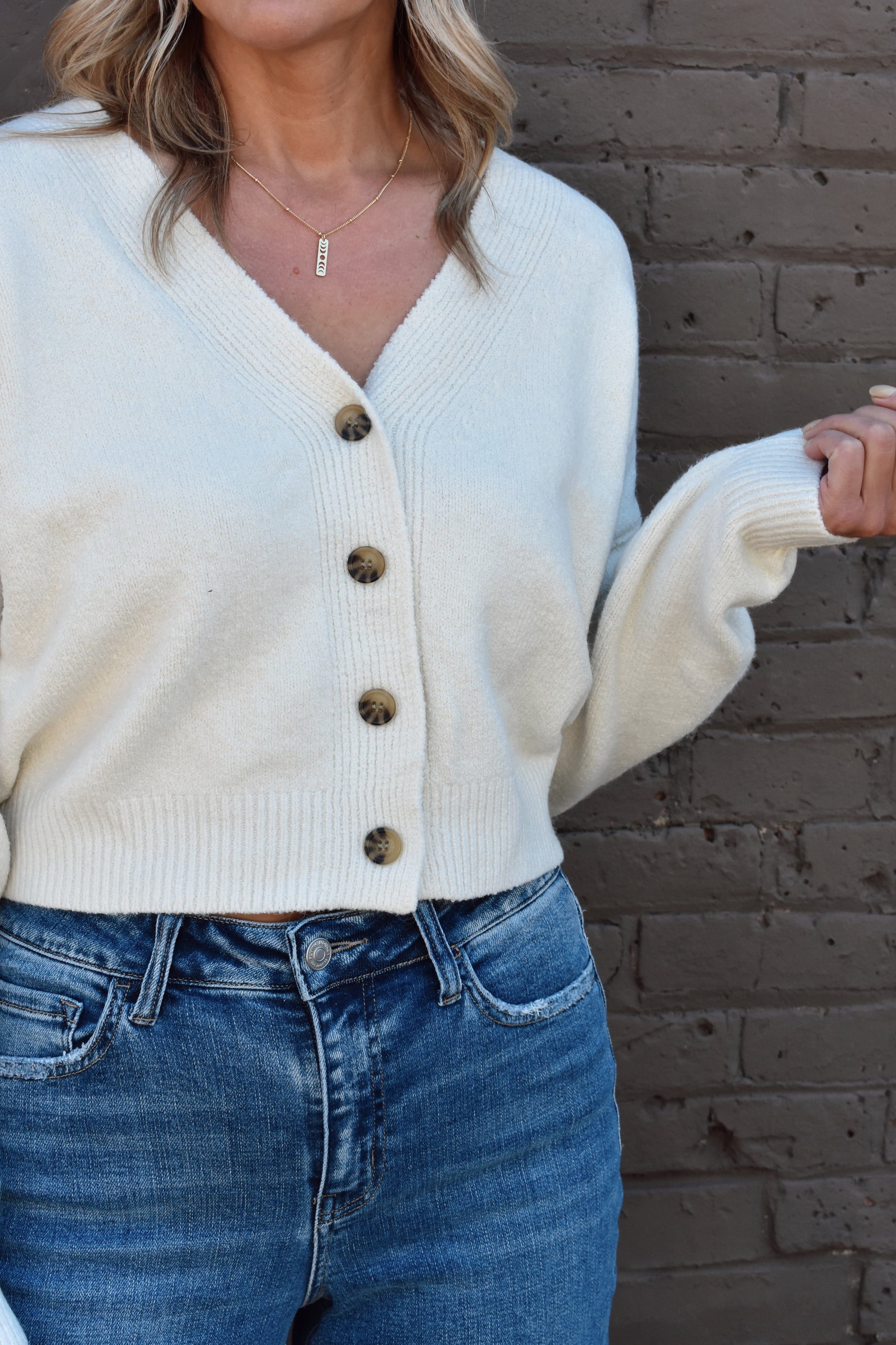 cropped v neck button front drop shoulder cardigan with ribbed cuffs and hem