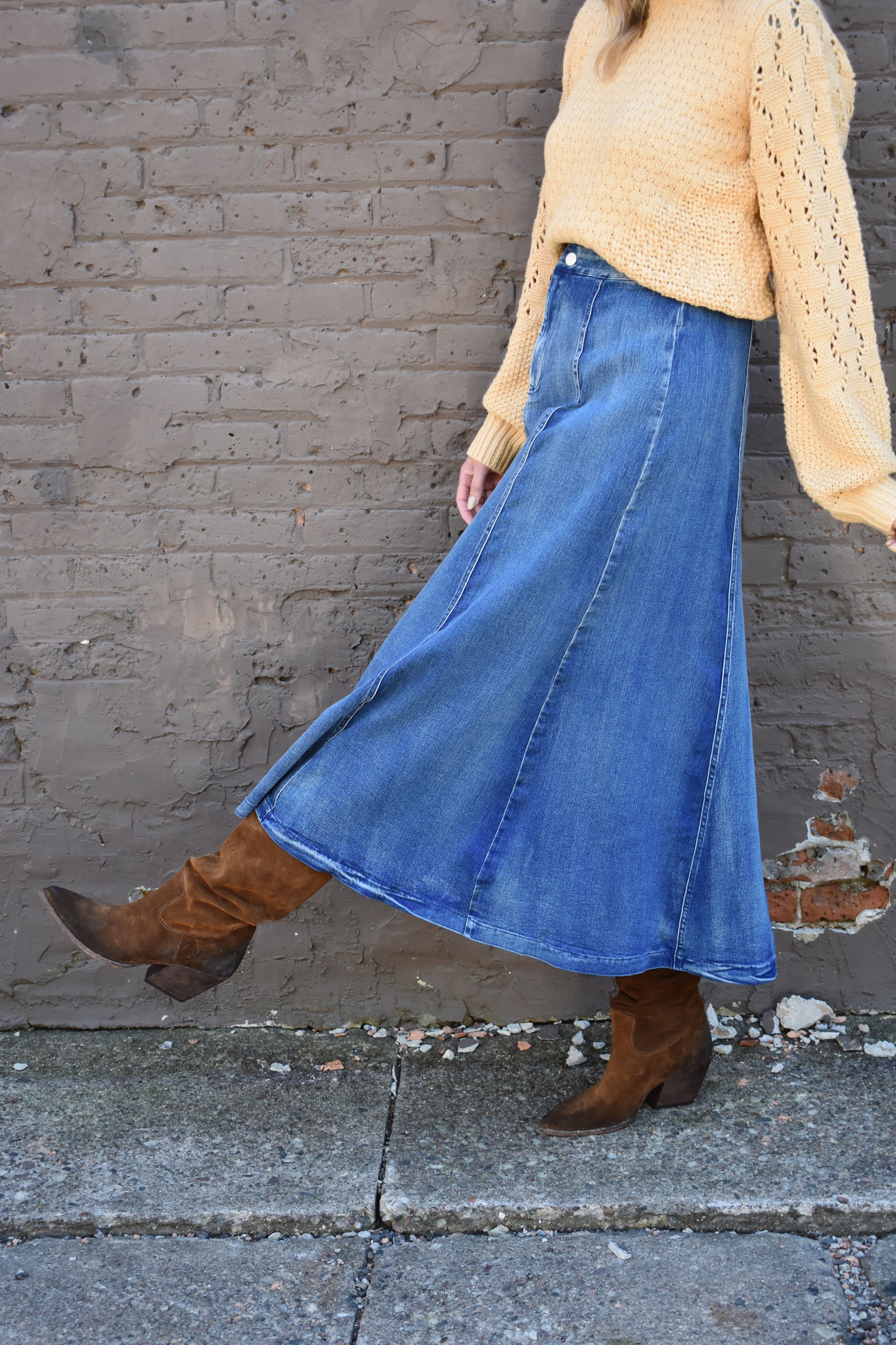 Denim swing midi skirt with seam detail along front, medium wash, button closure.