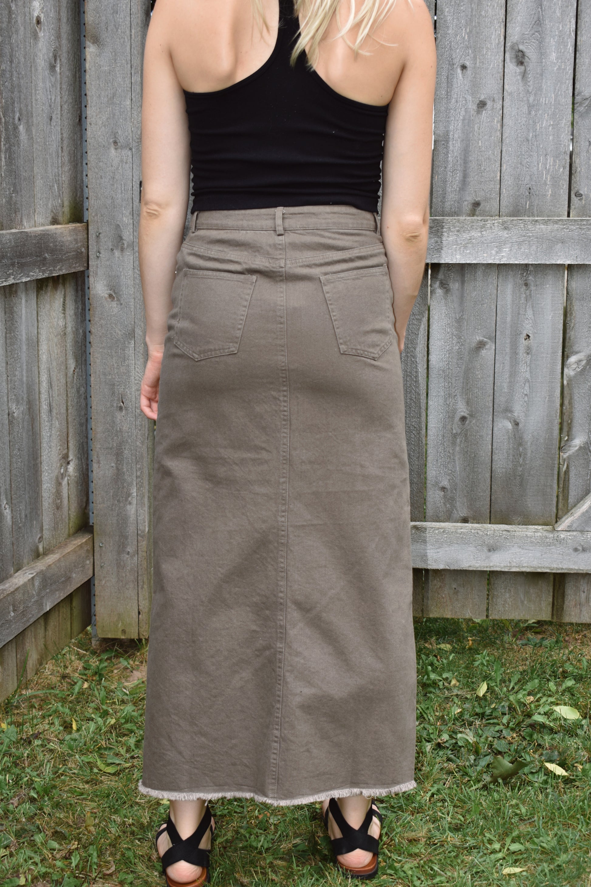 chesnut denim midi skirt with slit up the front in the center, raw hem, front and back pockets, zip and button enclosure