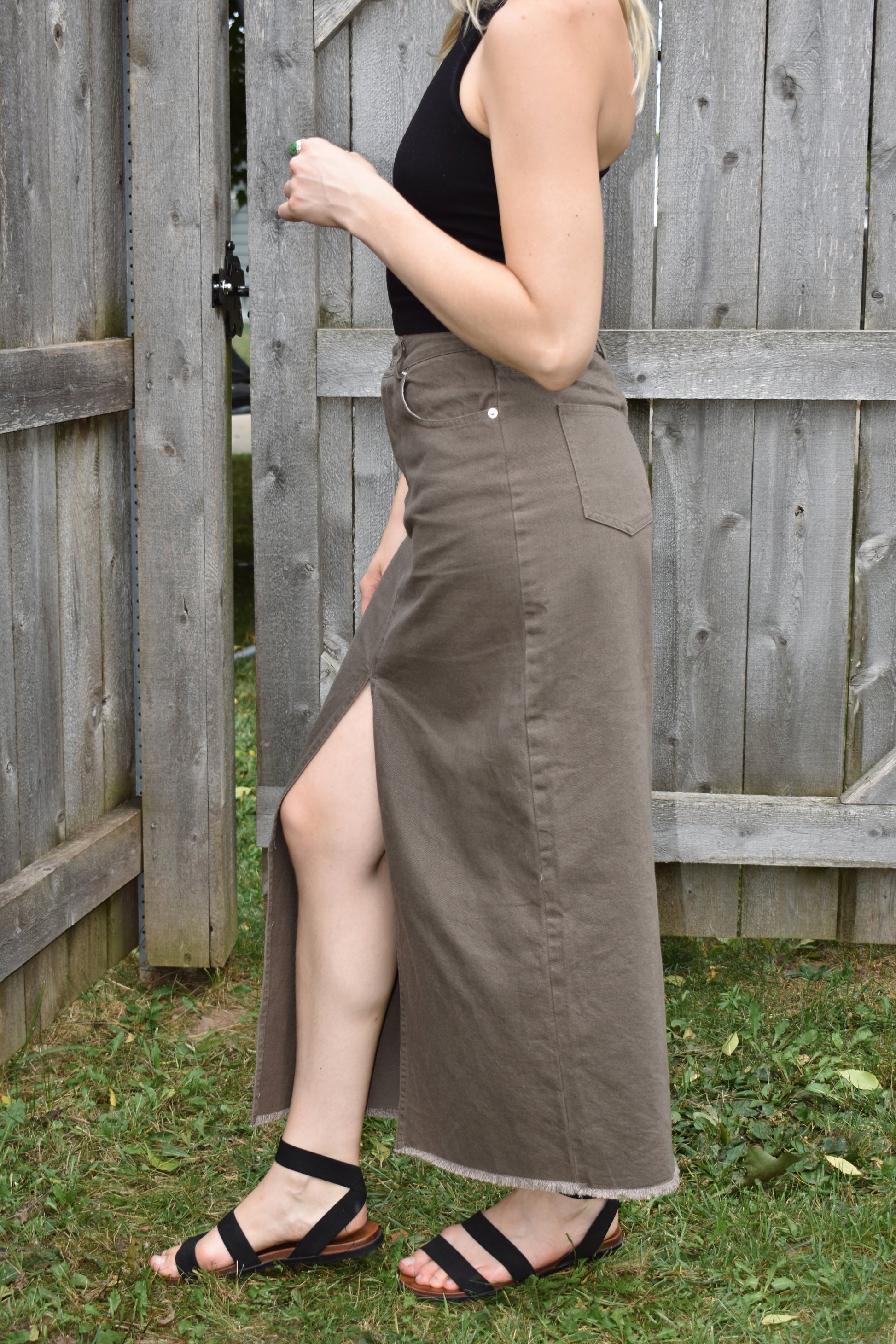 chesnut denim midi skirt with slit up the front in the center, raw hem, front and back pockets, zip and button enclosure