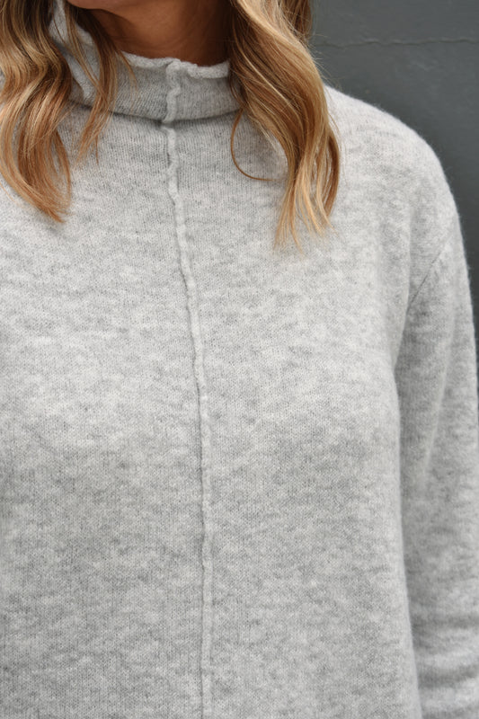 heather grey mock neck full length sweater with raw hem detail down the front. lightweight and soft fabric. 