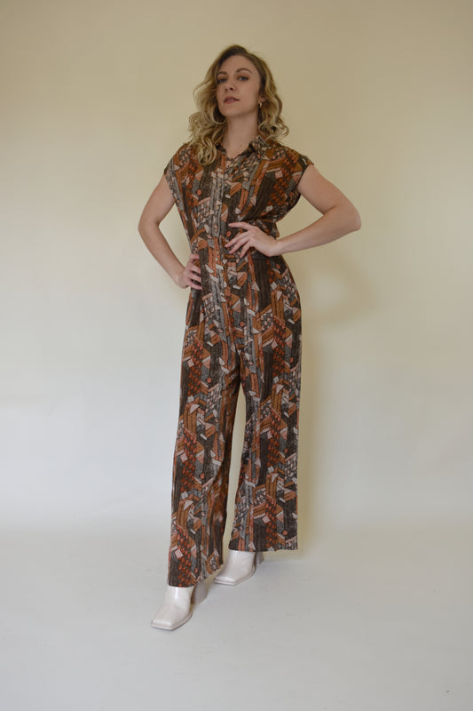 neutral/earth tone boho patterned jumpsuit with cap sleeves and collar with front button down. wide leg, synching in back with horizontal split on lower back so theres an open back effect but not revealing. 