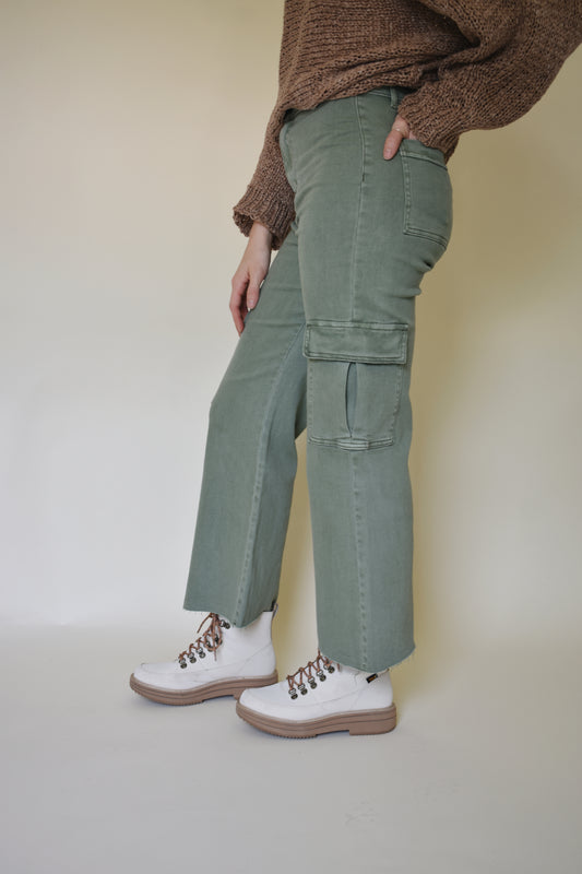 Wide leg cargo pants with pockets on side with flap and on the back. Button enclosure with belt loops. Raw hem. Sage green color. 