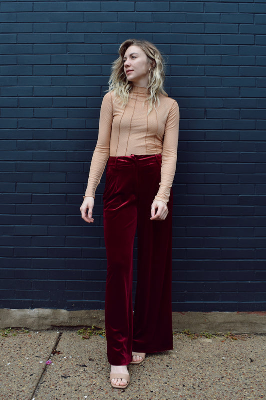 burgundy velvet trousers with front pleats by pockets, front zip and clasp enclosure, pockets, fake back pockets, wide leg, beltloops.