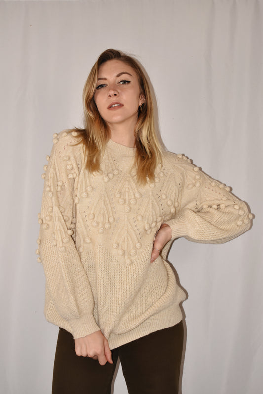 oversized knit full length cream colored sweater with pom pom detailing on the top half. slight balloon style sleeves. 