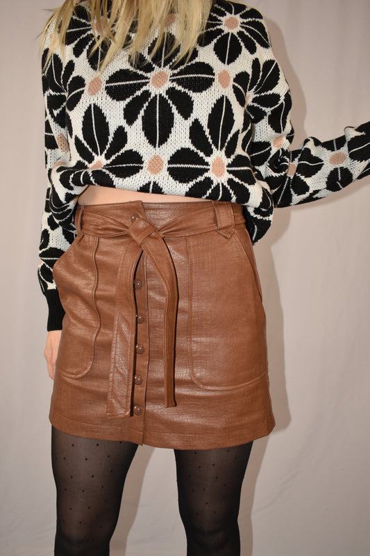 camel color vegan leather mini skirt with tie and snap down front with deep patch pockets on front.